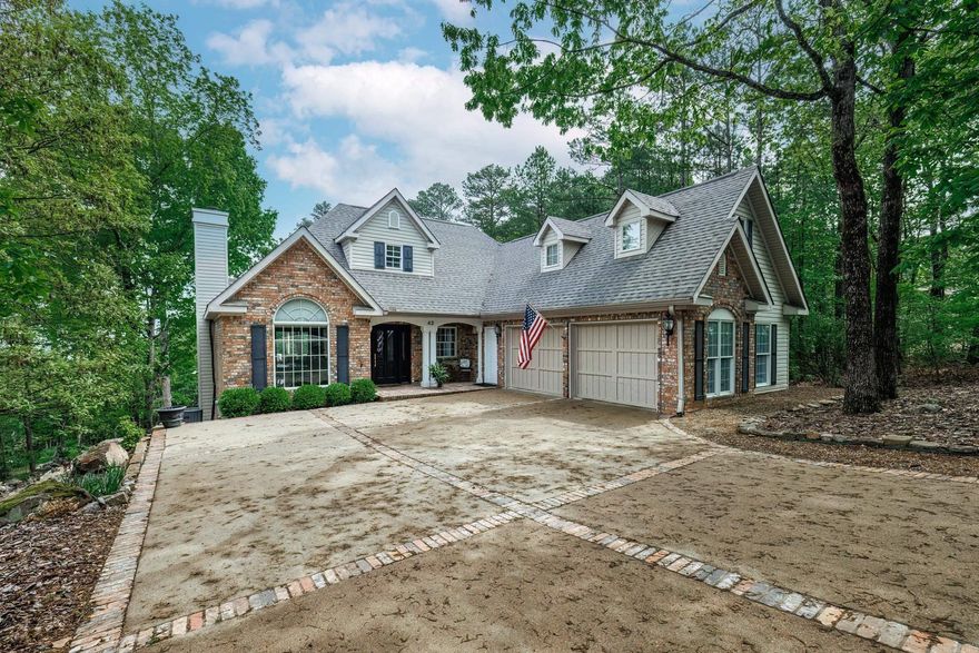 Beautiful mountain view home with flat entrance into the side load oversized garage with ample room to back out and drive to the street. Flat backyard that is almost unheard of at a view home. Partial summer view of Lake DeSoto and great winter view of the lake. Large primary bedroom and remodeled bath with double sinks, soaker tub, large walk in shower on entry level. Powder room on entry level. Kitchen has been updated with Quartz countertops and new backsplash. Pantry & moveable island. Engineered hardwood main level. Carpet on stairs only. Great views from the living area, breakfast area & primary bedroom. Fireplace with gas logs. Downstairs are two bedrooms with a Jack n Jill bath. Large heated and cooled room for crafts or work shop.  Storm safe room downstairs. There is abundant storage on both floors. Ceiling fans in all bedrooms and living area. Most lights are on dimmer switches. Large deck that is partially covered. Concrete patio on lower level. Roof replaced in 2019, Zoned HVAC is 6 years old and is serviced twice a year and water heater is 4 years old. Furniture is available separately. Square feet information furnished by seller and buyer is urged to verify.