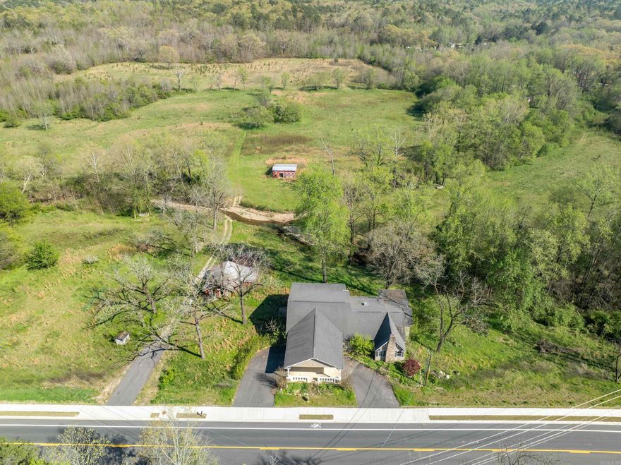 Take this opportunity to reclaim this beautiful creekside home on 63 acres with an amazing countryside view. This home needs lots of TLC, but has much to offer for either residential or commercial purposes with its historic charm. Conveniently located one mile from entry to new bypass. Also being offered with one surrounding acre, to be parceled off from parent tract. See MLS No. ____. Sold As-Is. No repairs.