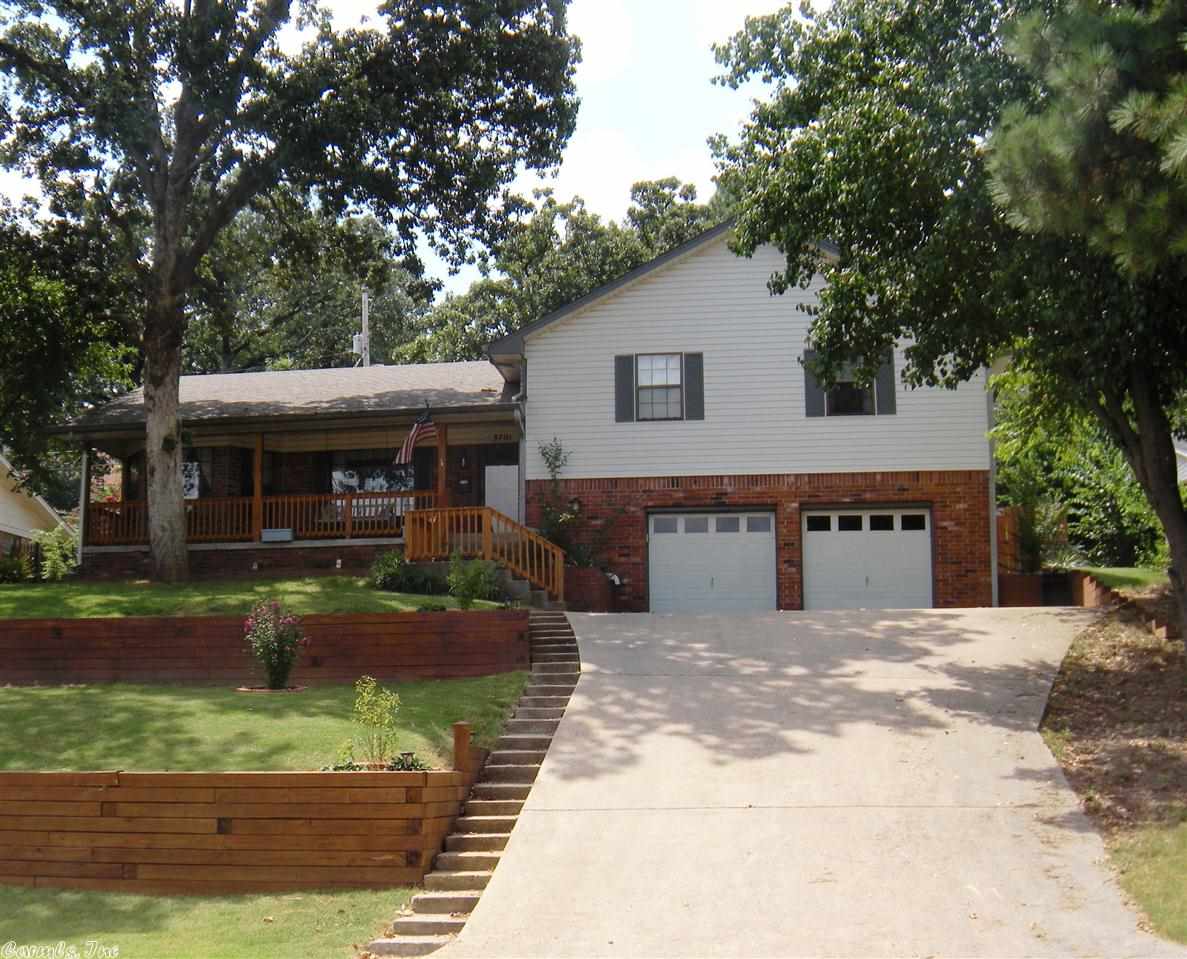 Walk to the Old Mill or sit on your front porch swing & watch the Lake, or go out back to the multi level decking and well landscaped privacy fenced backyard. This home has an updated kitchen with w/stainless appliances, fridge stays. New tile flooring in all the living spaces, carpet in bedrooms. 1/2 Bath & laundry in garage, laundry chute from both baths to the garage. Great sunroom off kitchen & greatroom. Don't miss the finished out storage area off the garage.