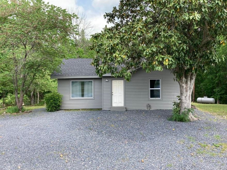 Starter or vacation home close to Lake Ouachita. If you're looking for a weekend getaway right outside the picturesque town of Mount Ida, then this may be the place for you! Two bedrooms and one bath. 1072 square feet. New vinyl siding and windows as well as a new roof in 2023. This home feels like staying at your grandma's with all the flowers and trees that surround the house. There's a magnolia tree in the front yard that is as old as the home itself. More acreage is available if interested. Remodel still in progress. Recent survey. City water. The new owner will have to install a mini-split or window units for A/C. Nine miles to Shangri-La Marina and six miles to Twin Creeks boat ramp and swimming area. Your vacation or forever home awaits!