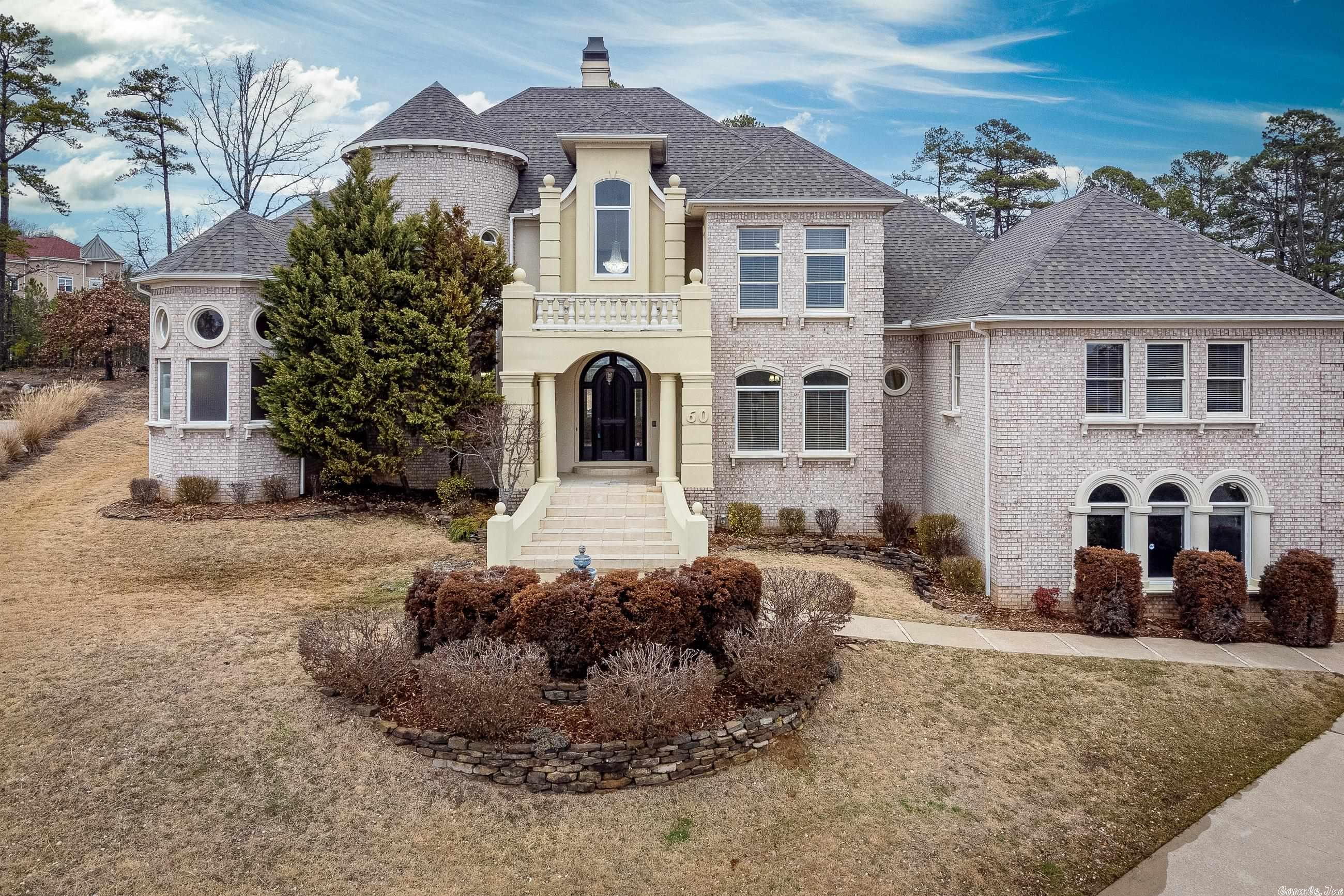Beautiful custom Chenal Valley home on a 0.73 acre lot in the Deauville Place gated subdivision. Soaring ceilings and a rounded staircase greet you as you enter the home. The large primary suite has an exquisite bathroom with large shower, jacuzzi tub and dual vanities. There is a study right off the primary suite with a 2 sided fireplace. Living room, Dining, kitchen & hearth room are also located on the main level. Kitchen has dbl ovens, gas range, new microwave and pantry. 5 steps up from the kitchen is large 2nd suite that could be a 2nd primary suite or bonus room. Windows all along the back of the home allow lots of natural light. Upstairs has 3 bedrooms all with private en suites and private balconies. Beautiful views, large private backyard & 3 car garage. This home has been very well maintained. Roof replaced in 2023. *Agents see remarks*