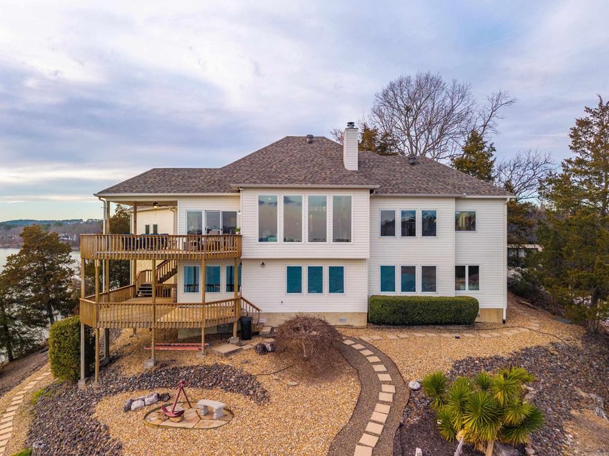 Nestled on the shores of Hot Springs Village and overlooking beautiful Lake Balboa, this 5-bedroom, 4.5-bath lakefront home offers breathtaking panoramic water views from two expansive decks designed for exceptional outdoor living. The main level features the primary bedroom and bath, living room with vaulted ceilings and new windows to maximize the incredible lake views, along with the kitchen and laundry for convenient one-level living. The lower level is ideal for entertaining and guest accommodations, offering additional bedrooms and baths, a sauna, game room, and media room. Additional highlights include a covered deck, private covered boat dock, and a roof with an extended warranty—providing peace of mind while delivering the ultimate Lake Balboa lifestyle experience.