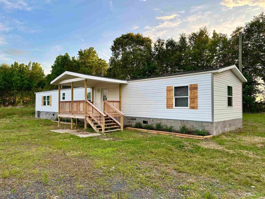 Enjoy living out in the country? Well check out this renovated manufactured home on 3 acres of FLAT LAND! This move-in ready home has 3 bedrooms and 2 baths, an open concept design features a layout where the living, dining, and kitchen areas are interconnected, allowing for greater flexibility and a more spacious feel. Fresh paint and new vinyl flooring throughout the house. Updated bathrooms with beautiful tiles! New deck to relax and enjoy your yard! Please schedule your showing now!