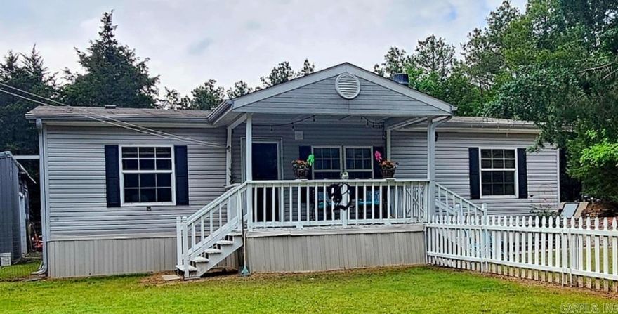 This well-maintained 3-bedroom, 2-bath home offers the perfect balance of peaceful living and everyday convenience. Nestled on 1.29 acres just minutes from Russellville, the home features a spacious layout, a welcoming living area, and a bright kitchen with plenty of storage. The primary suite includes a full bath and walk-in closet, while two additional bedrooms provide flexibility for guests, family, or a home office. Step outside to enjoy the beautifully landscaped yard, complete with a fenced area for pets and an above-ground pool—ideal for enjoying warm Arkansas days. Additional highlights include a covered carport and a detached shop, perfect for hobbies or extra storage. If you're looking for comfort, space, and move-in-ready convenience, this home checks all the boxes