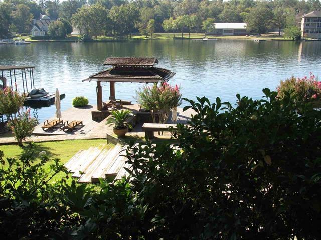 Lakeside Tropics! This ideal home offers a unique opportunity for maximizing lakefront living. Inside u will find 4 bedrooms, 3.5 baths with two spacious living areas. Vaulted ceilings, three stone fireplaces. Custom Kitchen with all the extras! Soap Stone counters, gas range, sub zero refrigerator, wine fridge, breakfast bar and a sun lit breakfast nook to enjoy your morning coffee or reading your favorite book. Downstairs is the greatest hobby room/office ever!