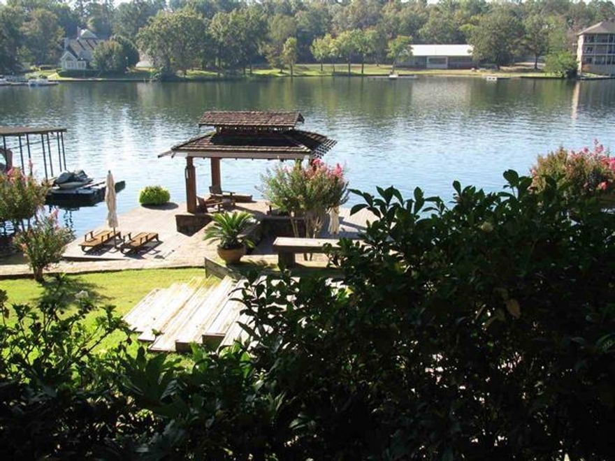 Lakeside Tropics!  This ideal home offers a unique opportunity for maximizing  lakefront living.  Inside  u will find 4 bedrooms, 3.5 baths with two spacious living areas.  Vaulted ceilings, three stone fireplaces.  Custom Kitchen with all the extras!  Soap Stone counters,  gas range, sub zero refrigerator, wine fridge, breakfast bar and a sun lit breakfast nook to enjoy your morning coffee or reading your favorite book.  Downstairs is the greatest hobby room/office ever!