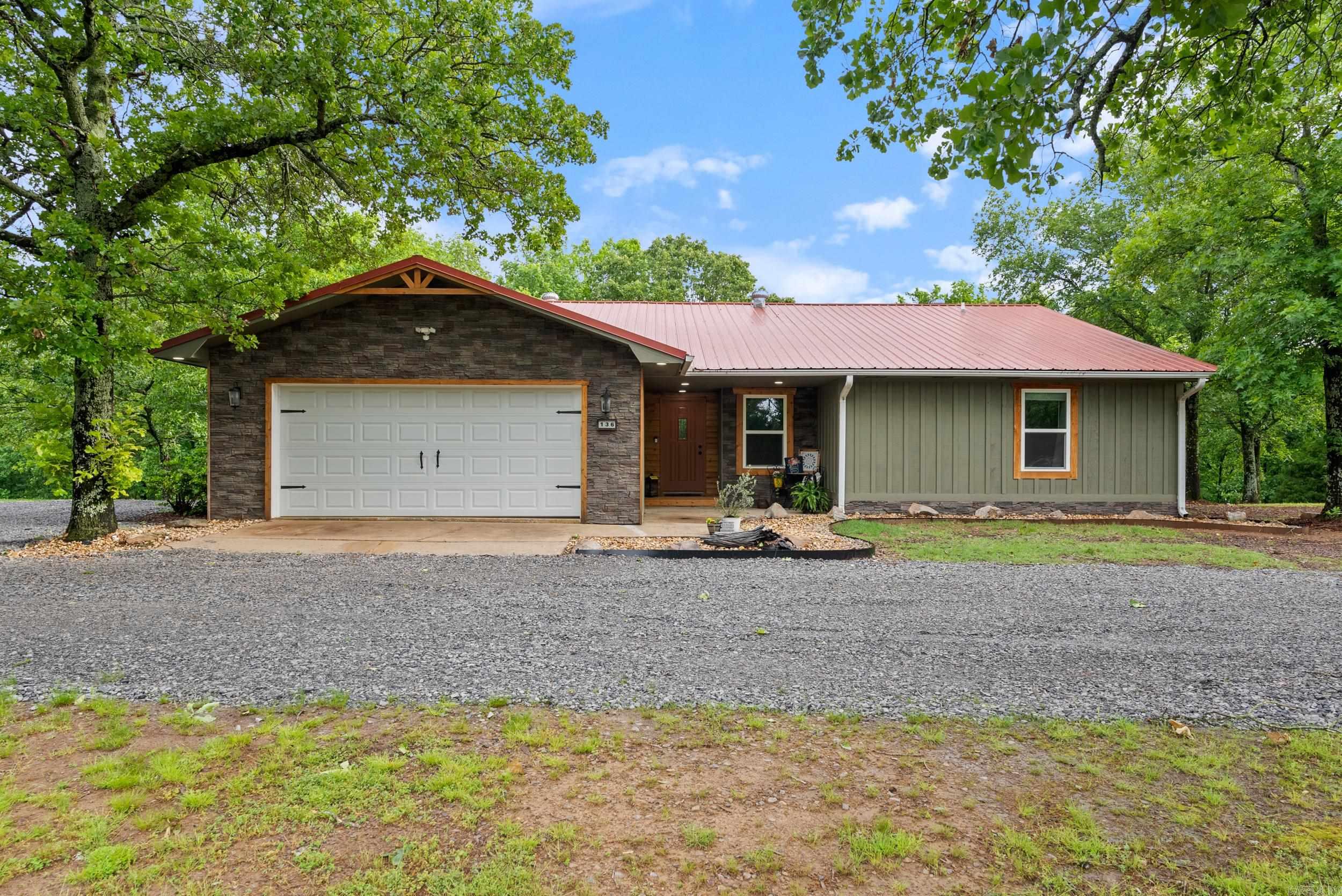 Imagine coming home to a beautifully remodeled home situated in a park-like setting on top of a beautiful Arkansas ridge. There's even a winter view down into the valley that could easily be year round by removing just a few trees. Luxury vinyl floors in the living areas with a gas log fireplace and solid wood beam in the living room that ties the space together perfectly. The kitchen features quartz countertops, a custom decorative tile backsplash, subway tile, and a dedicated coffee bar area. Large primary suite with custom tile shower in the bathroom and walk-in closet. The primary bedroom looks out to the back yard and woods behind the house. Just off the living room is the oversized covered deck with great views. The back deck is the ideal place to sip your morning coffee and take in the surrounding nature. Metal roof, which could help with insurance costs. Great location with easy access to the back gate at Little Rock Air Force Base. Easy drive to Conway, Cabot, and the Little Rock metro.