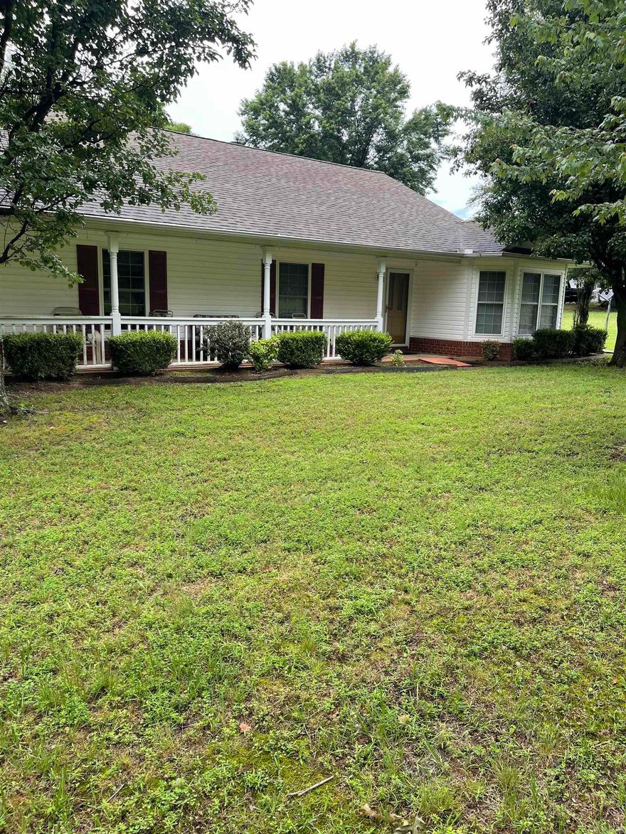 This immaculate home is move-in ready and is situated on a flat 2-acre lot. Designed by a professional architect in 1996 and built by a custom home builder, it features spacious bathrooms and his-and-her closets in the master suite. The large kitchen, along with a cozy fireplace, creates a welcoming atmosphere. Includes 3 bedrooms, 2 large baths, and Florida room.    The property includes a roomy two-car garage with two garage doors, plus an additional larger room at the end of the detached garage. There is also a well-equipped laundry room with a sink and plenty of cabinets for storage. Enjoy the outdoors from the wrap-around porch and take advantage of the spacious driveway, which offers ample turnaround space while keeping the beautiful lawn protected. And even a fenced area for Fido.    This lovely home had energy-saving upgrades installed 4 to 5 years ago, resulting in very reasonable electric bills.