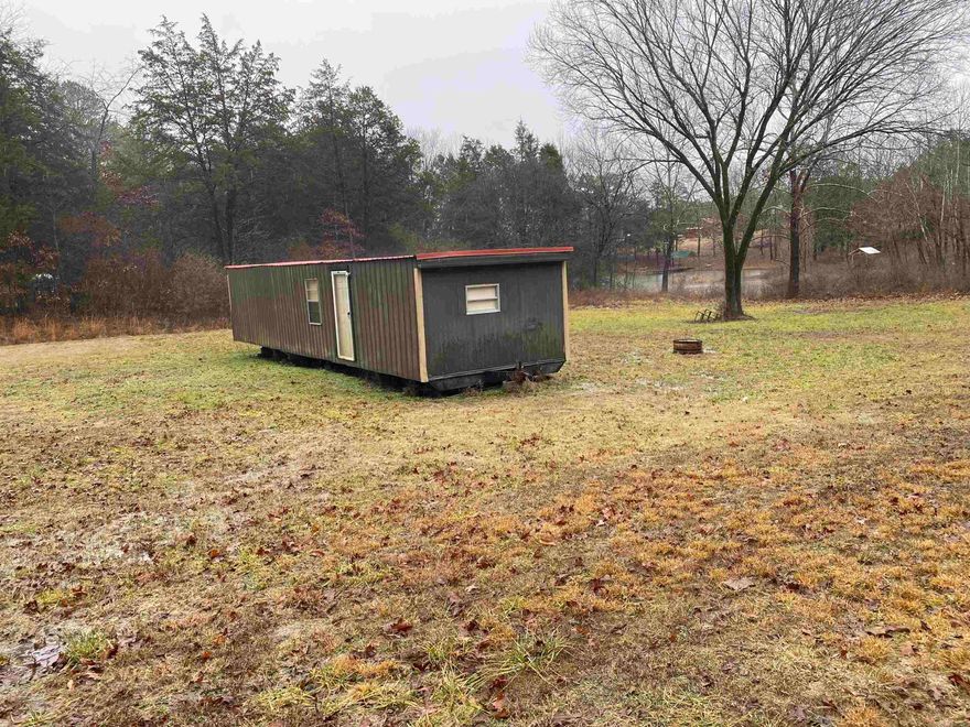 Great lake front  lot with remodeled mobile. Enjoy fishing on 40 Acre private lake.  Property owners have free access to community building, bathrooms, playground and picnic table. Make this  your week end get away or build your home.  Utilities are not installed yet. Drive by and give us a call today.