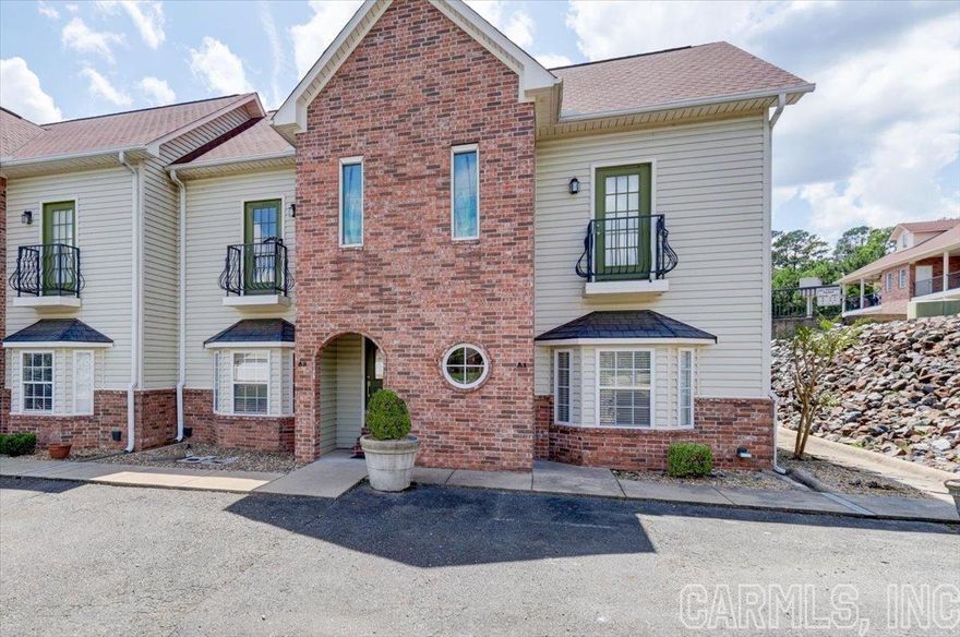 Perfect Vacation or Income Producing Property on Lake Hamilton just off Central Ave!  STR (short term rental) permit is in place and transferrable to a new owner!  Enjoy this ideal townhome for your own vacation time and let it pay for itself when you are not using it!  Two bedrooms & two full bathrooms... the primary bedroom has a walk in closet.  The electric fireplace adds ambience to a chilly evening and Fall football!  Summertime offers the inviting pool surrounded by patio area for owners & their guests for sunbathing, relaxing or swimming plus just a few steps away is the development's boardwalk for boat tie ups on Lake Hamilton making it easy to enjoy days on the lake!  Fenced patio for privacy, grilling and enjoying nature.   Located close to restaurants, shopping, a straight shot to Oaklawn Racing & Casino as well as our famous Historic Downtown.  And with a $5000 flooring allowance included, you can choose the perfect finishing touches to make this townhome your own. Don't miss this opportunity to own a stunning townhome with a private pool and lake access in a prime location.  Schedule your showing today!  $5000 flooring allowance.