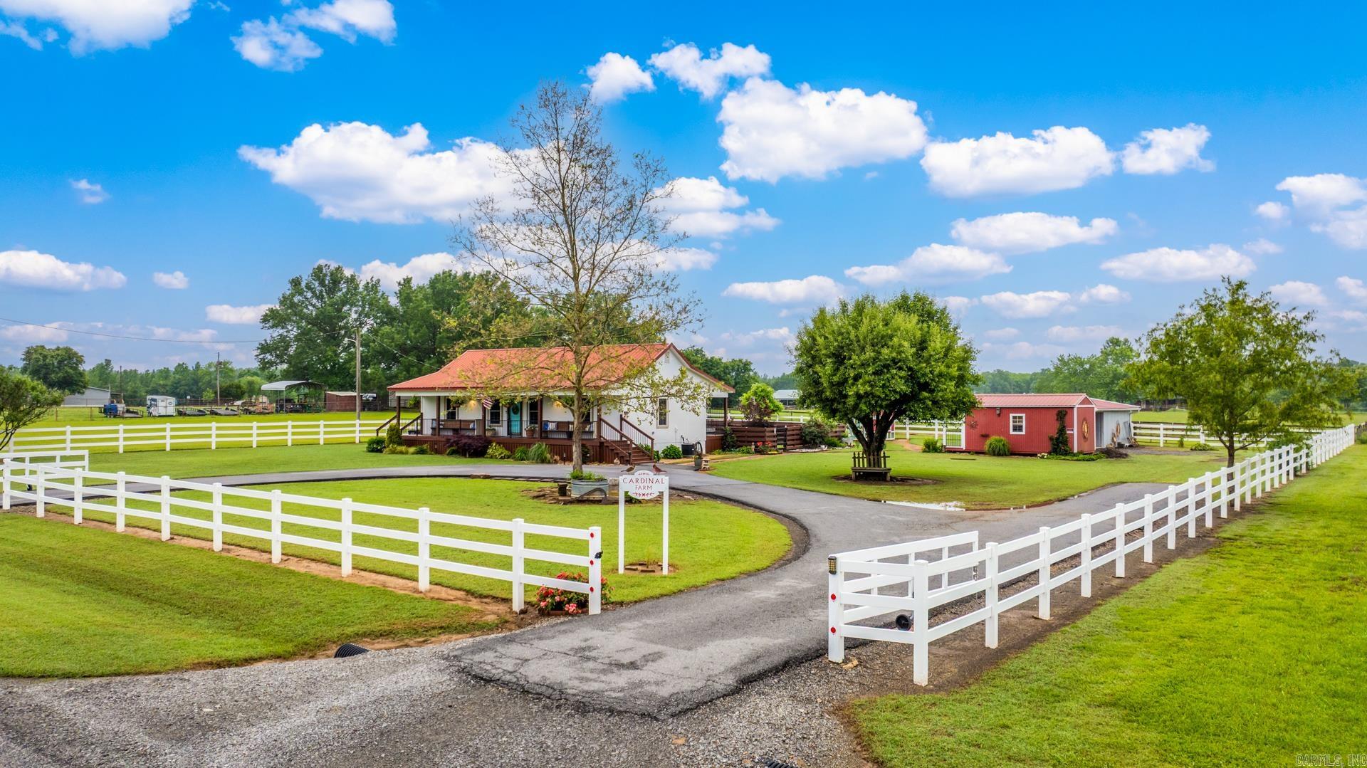 Luxury Countryside Retreat ā Fully Renovated Modern Farmhouse on Pristine Acreage.Step into refined country living w/this beautifully reimagined farmhouse, blending modern luxury w/timeless charm.This fully fenced estate features a grand front porch w/antique church pews, custom ironwork & a circle drive w/RV/trailer pad.Inside enjoy wide-plank hardwoods, vaulted wood ceiling in Living area, bespoke millwork & a chefās kitchen w/deep custom cabinetry, quartz/marble surfaces, farmhouse sink & premium appliances.Both bedrooms offer generous closets w/built-ins, while two spa-inspired baths showcase oversized walk-in showers, designer vanities & elegant fixtures.Outdoor amenities abound: landscaped gardens, a private fenced courtyard, multiple frost-free hydrants, wired patio, custom pergola & three outbuildingsāwired barn (ready for livestock or vehicles), finished shed w/electricity, and a fully equipped custom chicken coop w/electricity & ceiling fans.Extras include double-pane windows, water filtration, storm/security doors, Ring system & negotiable furnishings 7/or equipment. A true turnkey rural estate ideal for hobby farming, equestrian use, or serene luxury living