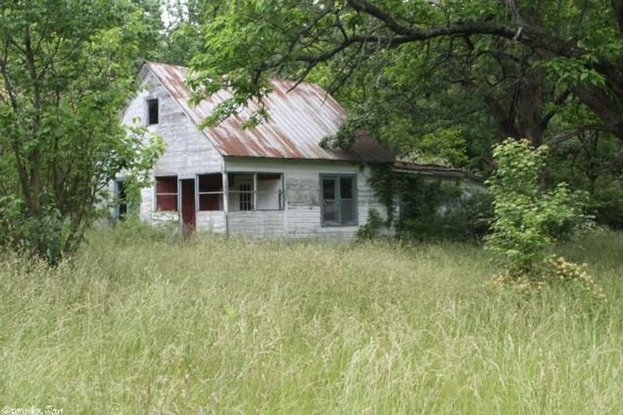 An older house on 6 lots.  Use some of the materials to build and have a 2 acre lot. It has city water.