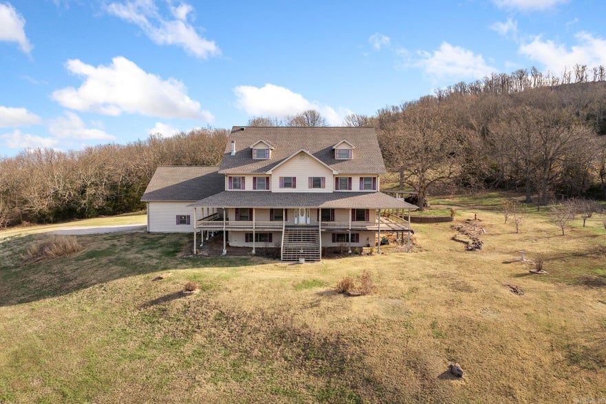 One-owner, custom-built 9,600 sq ft home offering exceptional space, privacy, and panoramic views in the Arkansas Ozarks. This impressive property features 6 bedrooms plus a bonus room, 4 full baths, and 2 half baths. Designed for comfort, durability, and large-scale entertaining, it’s ideal for a Bed & Breakfast, Airbnb, or corporate retreat. The home easily accommodates guests with its generous layout and multiple living areas. Key features include a whole-house generator, in-house sprinkler system, outdoor Hardy wood furnace, propane cooktop, multiple HVAC systems, and a brand-new roof (2023). It also offers a spacious three-car garage and solid construction throughout. Available on ~10 acres or ~40 acres (with pond and barn). Enjoy absolute privacy, usable land, and breathtaking long-range views from every level. Located just outside Big Flat and Harriet, with Marshall and Mountain View both about 30 minutes away.