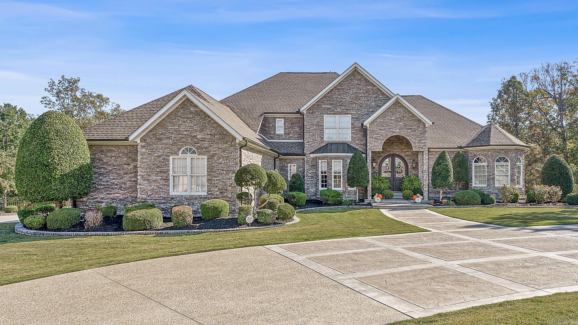 Experience luxury living in this stunning custom-built two-story home with a full walk-out basement! Enjoy the expansive raised concrete patio and screened porch, perfect for relaxing outdoor moments. Inside, you'll find an island kitchen with top-of-the-line features, including a brand-new gas cooktop, ideal for culinary enthusiasts. The home boasts soaring ceilings, a dedicated home gym, and a private sauna for your wellness retreats. Situated on three spacious lots totaling 1.91 acres, this property borders a golf course and even includes its own basketball court. The layout offers flexibility with a master suite on both the main floor and downstairs, as well as two additional bedrooms and two bathrooms on the upper level. The fully finished basement provides two family rooms, an additional kitchen, gym, two full baths (one with a sauna), and two more bedrooms—perfect for multi-generational living or entertaining guests. A three-car garage completes this must-see home.