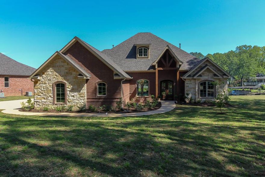 Prestigious 7 South location for this gorgeous Carriage Lake Home.  This brick and stone home has the perfect backdrop,  sitting on an almost flat lot with a view of the 7 South Bridge and open water.   It features everything you'd expect in a Carriage; soaring ceilings, an abundance of trim and windows, upgraded fixtures, professionally decorated,  landscaped with seawall, and covered boat dock+ swim dock.   Taxes are based on lot only.