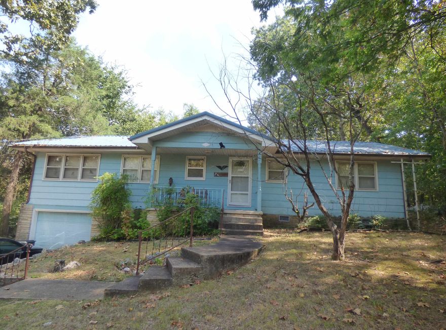 3 BEDROOM HOUSE LOCATED CLOSE TO LAKE THUNDERBIRD - This house offers 3 bedrooms, 1/2 baths, hardwood floors, living room, kitchen, bonus room, one car garage, 3 year old HVAC system, metal roof, unfinished basement great for storage or could be made into a family room.  The house is located walking distance to Lake Thunderbird which is a 260 acre recreational lake located in the heart of Cherokee Village.  Spend evenings sitting on the back deck and enjoying nature and the peace and quiet of our beautiful community.