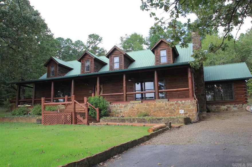 Spacious custom-built log home full of character and charm on acreage in quiet, rural area. 3519 sq ft (per appraisal) w/ 3 beds/2.5 baths. Woodburning fireplace w/ massive  chimney made of native stone; Buck stove insert. Stainless steel appliances (refrig. incl.) walk-in pantry. Huge master suite w/cedar-lined closet and private deck access. Metal roof.  HVAC replaced 2015. Appliances replaced 2017.  Security system.   [AGENT  REMARKS]