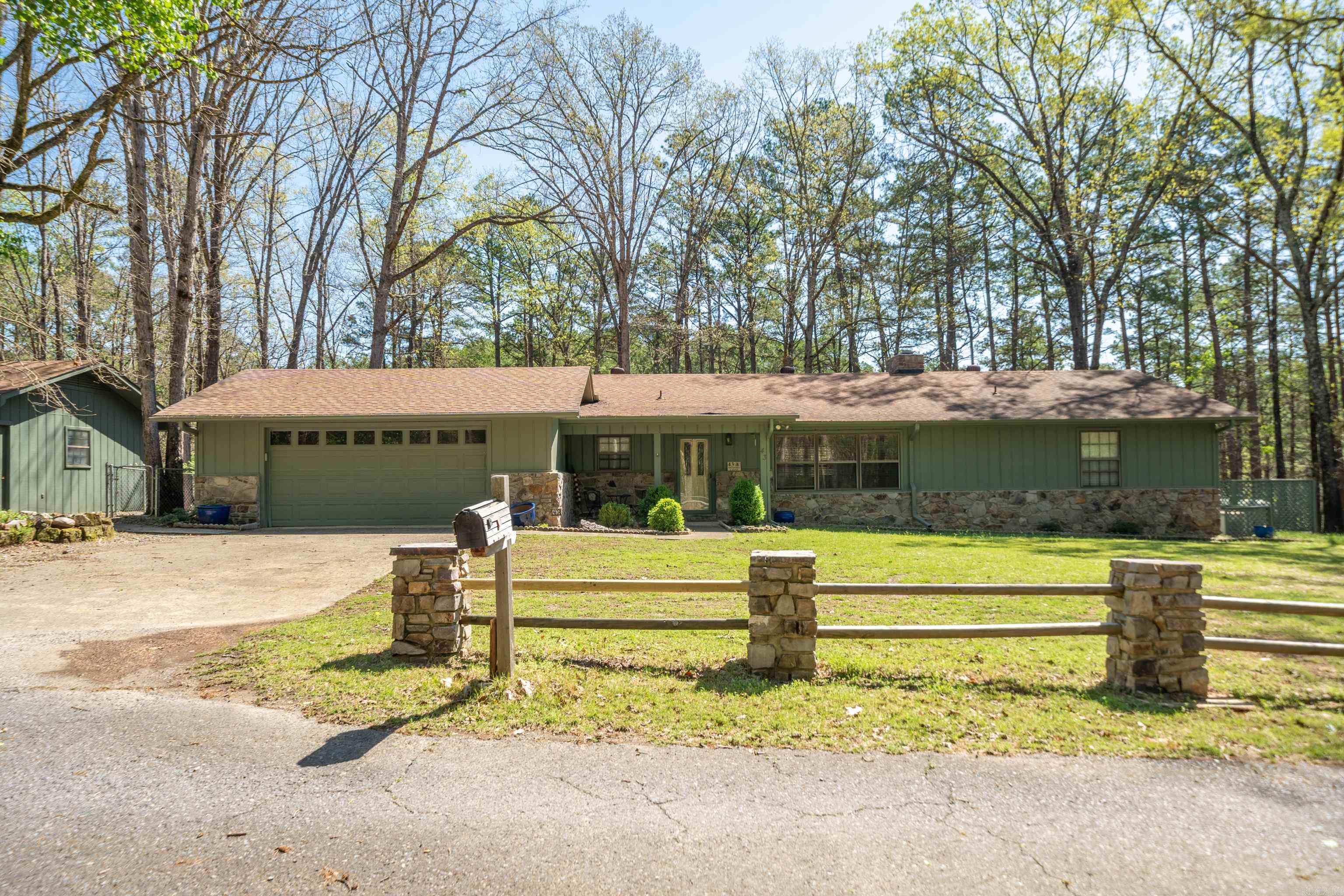 HOUSE COMES FULLY FURNISHED!! Beautiful renovated home on 1.35 acres, no expense spared and located in Mountain Harbor on Lake Ouachita. 1 Mile from lake, with detached garage, extra covered RV or boat storage! This is a very rare find to have a home in this area without POA restrictions. 2 levels with flagstone patio in the back, grill area, covered outdoor dining, WHOLE HOUSE GENERATOR, wonderful neighbors who live there year round. Bunk room with 8 bunks, perfect for the kids and game room Would consider owner financing with adequate down payment.
