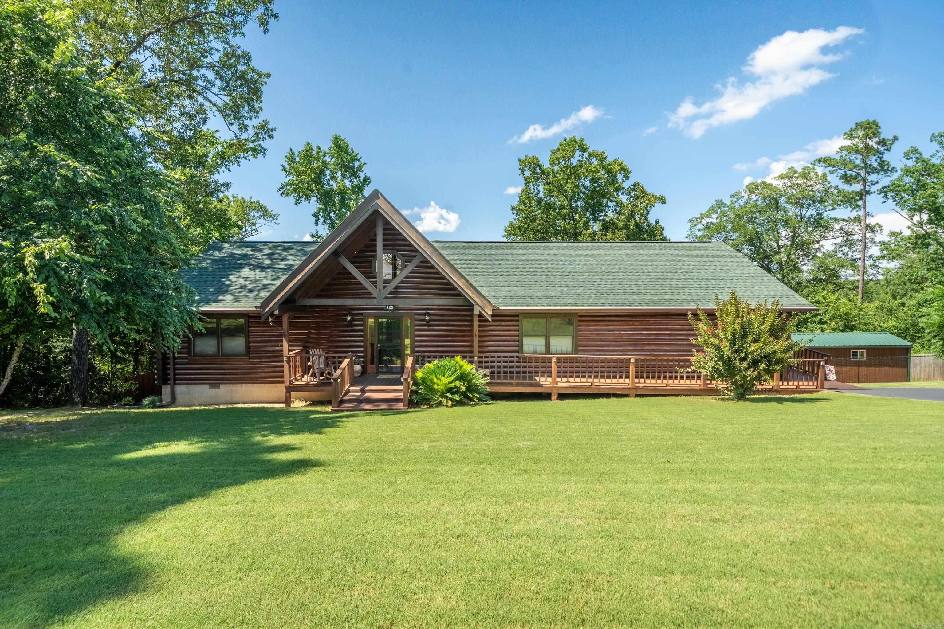 Charming 3 Bed, 2 Bath Log Home in Lakeside School District! Nestled in a serene setting, this beautiful log home offers the perfect blend of rustic charm and modern convenience. Featuring 3 spacious bedrooms and 2 full bathrooms, this well-maintained property includes a fully fenced yard, ideal for pets or activities. Enjoy your mornings on the screened-in back porch, or get creative in the separate shop—perfect for hobbies or extra storage. Security doors on all entrances provide peace of mind, and the heated and cooled basement room offers bonus space for a home office, gym, or storage. Located in the desirable Lakeside School District, this home has it all!
