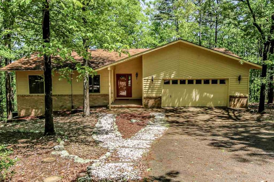 This home is tucked privately in the woods with a winter mountain view. There are two finished levels, natural landscape, generous two car garage, screened deck, as well as open. A new heat pump and hot water heater were installed approximately 2 years ago. THere's also a Generator which will convey. Multi purpose room, wet bar, fireplace, bedroom, full bath - lower level. This is a LOT of house for the money!