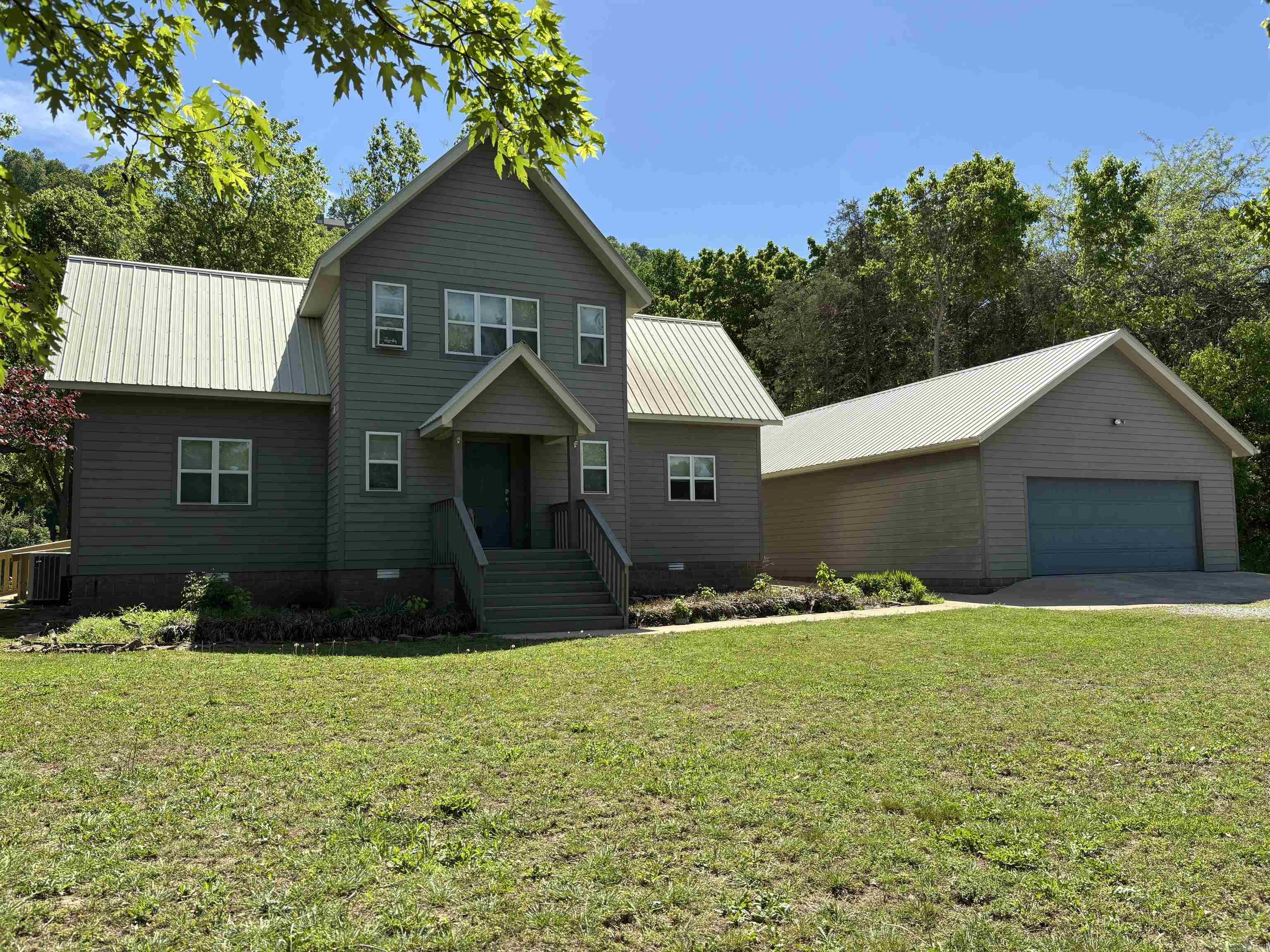 Beautiful modern, contemporary home right on the White River! Close to town, Anglers Restaurant, both Game and Fish boat launches, just minutes from Blanchard Springs, Sylamore National Forest and Sylamore Creek! High ceiling in LR, fireplace, Primary BR with king bed and full bath downstairs, loft with two twin beds, bathroom and 2nd bedroom with king bed upstairs. Half bath in foyer, Bunk room in backside of garage with a king bed and two bunk beds, two car parking in the front side. Large two-tiered deck overlooking the river, handicap access to the deck, fire pit, mature trees front and back. The refrigerator, washer and dryer convey. Additional furnishings may be available for purchase. This is a beautiful home and a āMust Seeā! Agents please read all Remarks.