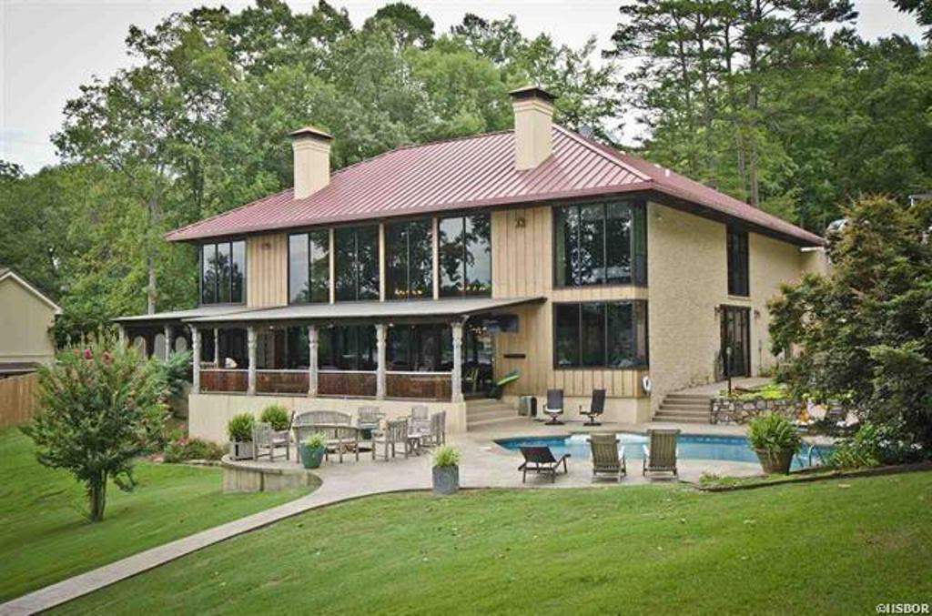 Luxurious Estate with 250 ft. of beautiful lake frontage. The privacy and serenity of this home are apparent as soon as you pass through the gates. The waterfront property lends itself to a relaxing getaway complete with a private boat dock, awesome views, and direct lake access. 6 bedrooms, 4.5 baths, English pub and billiards, stately great room, quality dining space, grand kitchen w/ custom cabinets and commercial appliances, lanai/living spaces. There is also a 1 Bd /1Ba Guest Cottage on the grounds.