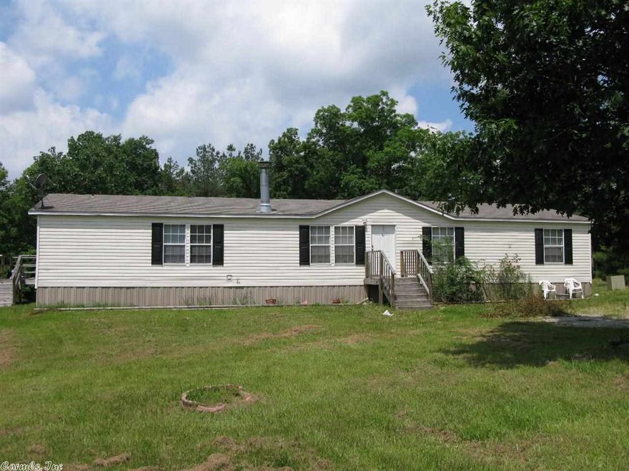 Go Wading in your Back Yard!  The Little Mazarn runs along the back of this property conveniently located close to Lake Hamilton Schools.  This rare 5 bedroom/3 bath home is sitting on 1.76 has 2232 sq. ft. & features hardwood laminate floors, an open floor plan with split bedrooms, a huge dining/living area with wood-burning fireplace, big eat-in kitchen, utility room & deck.  Property being sold "as is".  Price reflects work needed to property.
