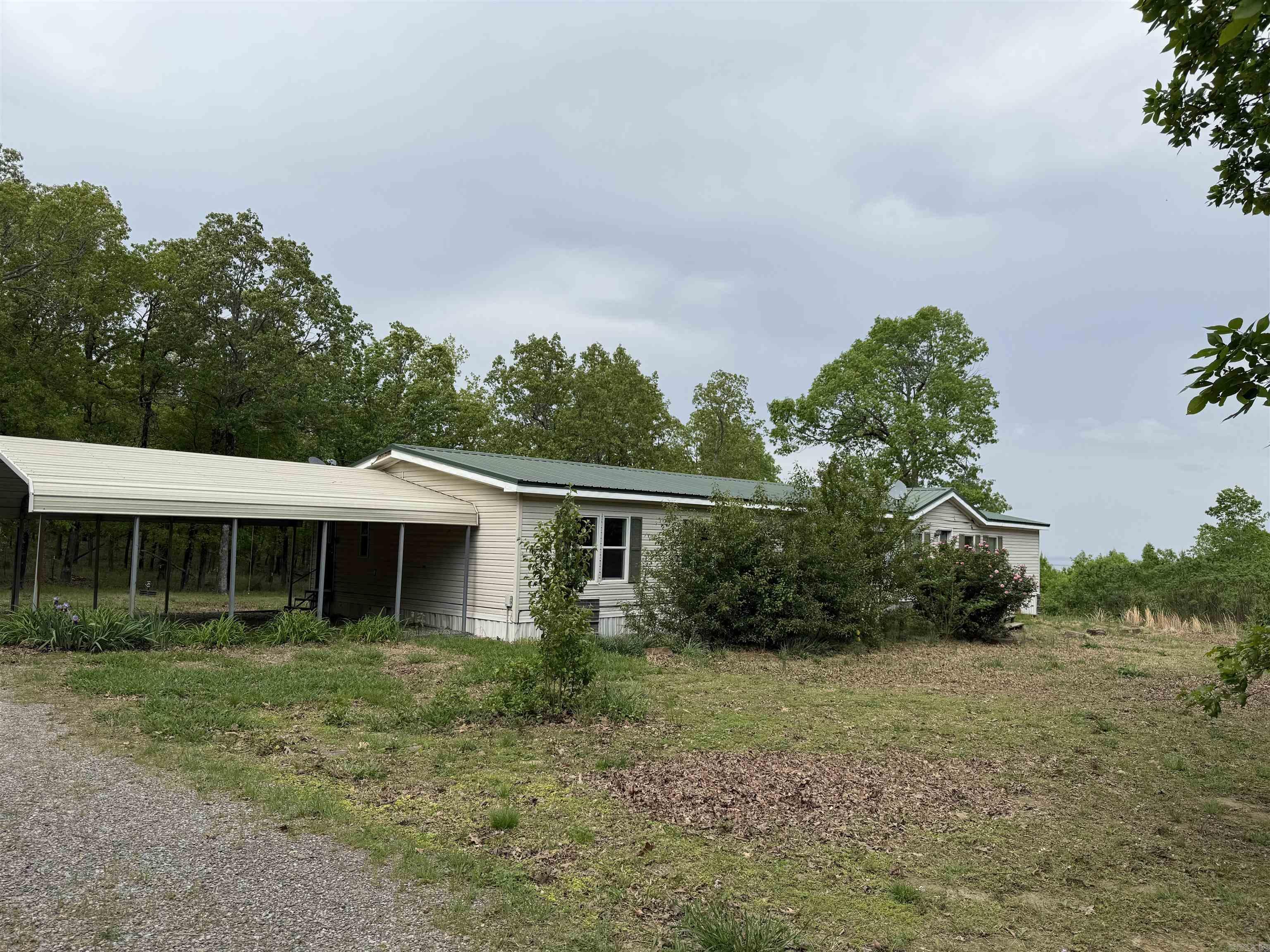 This 4-bedroom, 2-living area double-wide mobile home offers plenty of space and potential! Nestled on 5.15 scenic acres, the property features a large deck perfect for enjoying the beautiful views, a carport, and a storage building/shed for all your tools or hobbies. The property is being sold as-is with no utilities currently connected.