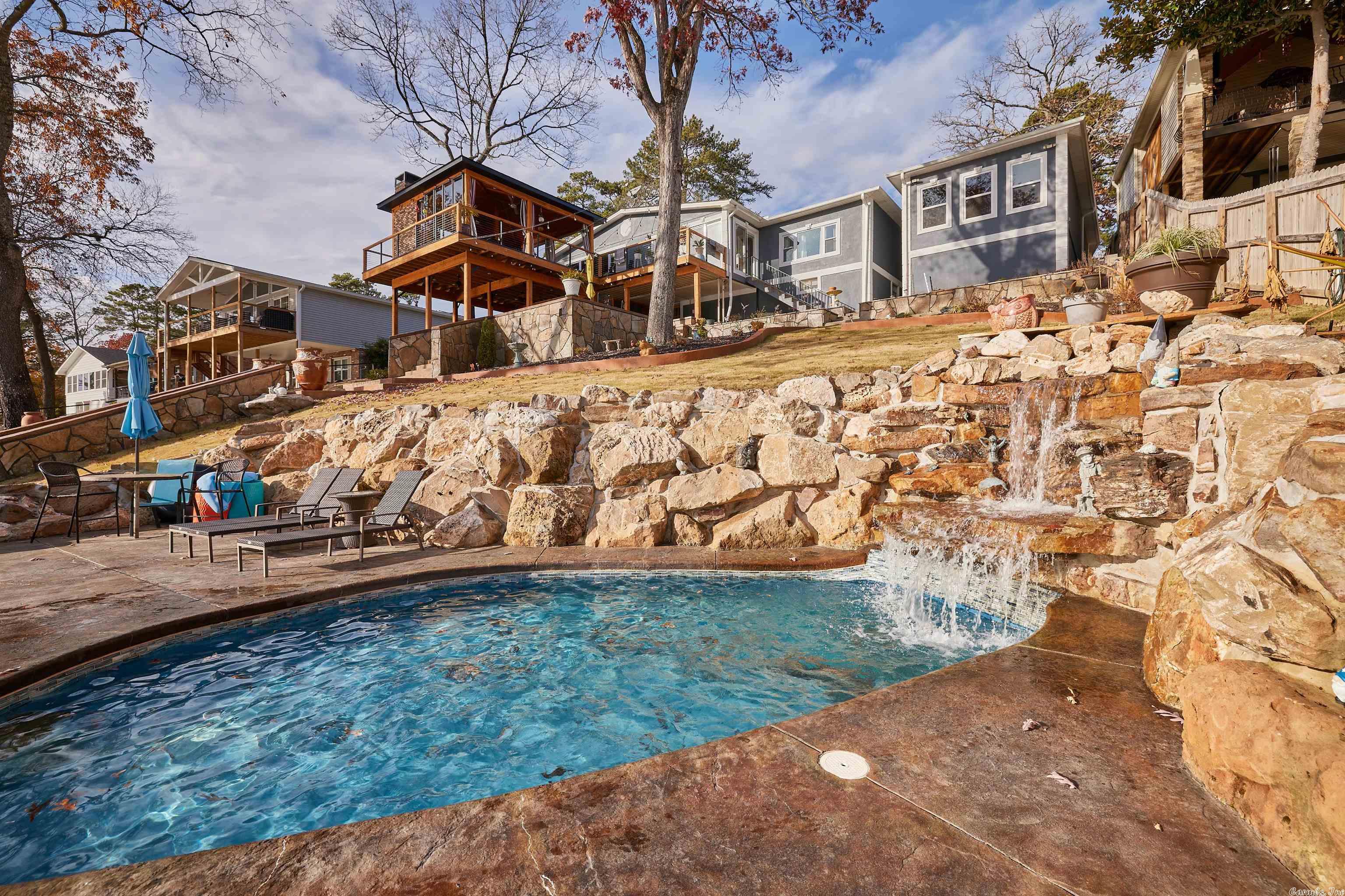 LAKE FRONT, DEEP WATER YEAR ROUND,GREAT VIEWS FROM EVERY WINDOW FACING THE LAKE! A SINGLE STALL COVERED BOAT SLIP WITH A LIFT AND A SWIM DOCK. NEW ROOF ON HOUSE IN 2020, NEW GARAGE AND CARPORT IN 2020 THAT ALSO MAKES A GREAT MAN CAVE. NEW GRANITE COUNTER TOPS,APPLIANCES AND FLOORING IN KITCHEN, ALL NEW COVERED DECK WITH SLIDE OUT GLASS SO YOU CAN ENJOY THE DECK EVEN ON COLD OR WINDY DAYS. MASSIVE STONE WALK WAY THAT GOES DOWN TO THE LAKE AND TO THE WATERFALL AND IN-GROUND WADING POOL. THE EXTRA LANDSCAPING, NEW SEAWALL, NEW CONCRETE DRIVEWAY, PERGOLA ON FRONT PORCH, NEW SOD AND SPRINKLER SYSTEM MAKES THIS LAKE HOUSE ONE THAT YOU DO NOT WANT TO MISS!!