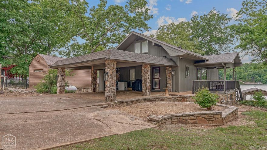 Lake house living in one of the best locations on beautiful no wake Lake Seqouyah which connects through canal the to Lake Thunderbird! This home truly offers it all. Situated on a point lot with approximately 1.5 lots, the property provides exceptional water access and views. The exterior amenities include a private sand beach, covered boat storage, two docks accommodating up to five boats, a large fire pit, RV parking pad with electric, septic, and water hookups, a storage building for lake toys, and more. Inside, the home features panoramic lake views and an open floor plan that is ideal for entertaining. The main level includes the kitchen, breakfast area, dining area, one bedroom, storage closets, and a full bathroom. The kitchen offers a stainless steel stove and microwave, along with a breakfast bar for easy serving. The living room showcases faux wood beams and a large stone fireplace. Just off the main living area is a wraparound deck, perfect for grilling and relaxing, with a covered seating area. Upstairs, you'll find two spacious bedrooms that can accommodate multiple beds for guests, along with a full bathroom. This is a must see property! Schedule a showing today!