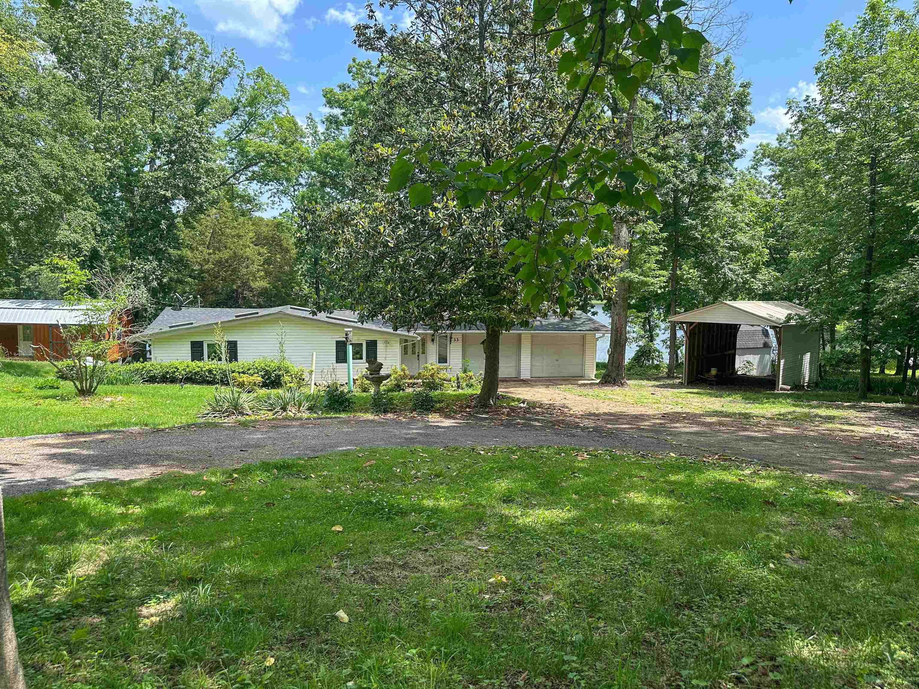 Unlock the potential of this incredible 3 bedroom, 2 bathroom fixer-upper, perfectly situated on two gently sloped lots with approximately 140 feet of prime Lake Cherokee lake frontage. Enjoy direct access to the water from your private dock. This property boasts abundant extra storage, mature landscaping, and the peace of mind of a Generac whole home generator, ensuring comfort year-round. While it needs some tender loving care to reach its full glory, this is a rare opportunity to customize your dream lakefront retreat. Don't miss out on this exceptional chance to own a piece of paradise on Lake Cherokee!
