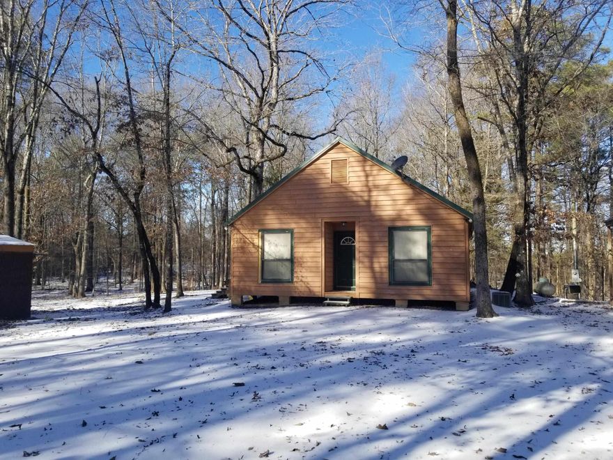 This nice 2 bedroom, 1 bath cabin on 10.5 acres, has a 4'x4' covered area at the front door. It also has a 220 sq. ft. screened back porch that goes out to a 210 sq. ft. wooden deck. There is a really nice pathway from the deck to the large stone firepit. There are tile floors throughout the house and it has an open floor plan. The interior is beautiful pine wood walls and ceilings. The bathroom has a tub/shower and a large vanity with double mirrors. It has central heat and air, a wall propane heater and also a pellet stove. All appliances stay, even the washer and dryer. The storage building that has a lean to shed on it to park a vehicle, ATV and etc. stays.           Outdoor parking available on the property. Nice place to just get away and enjoy nature.