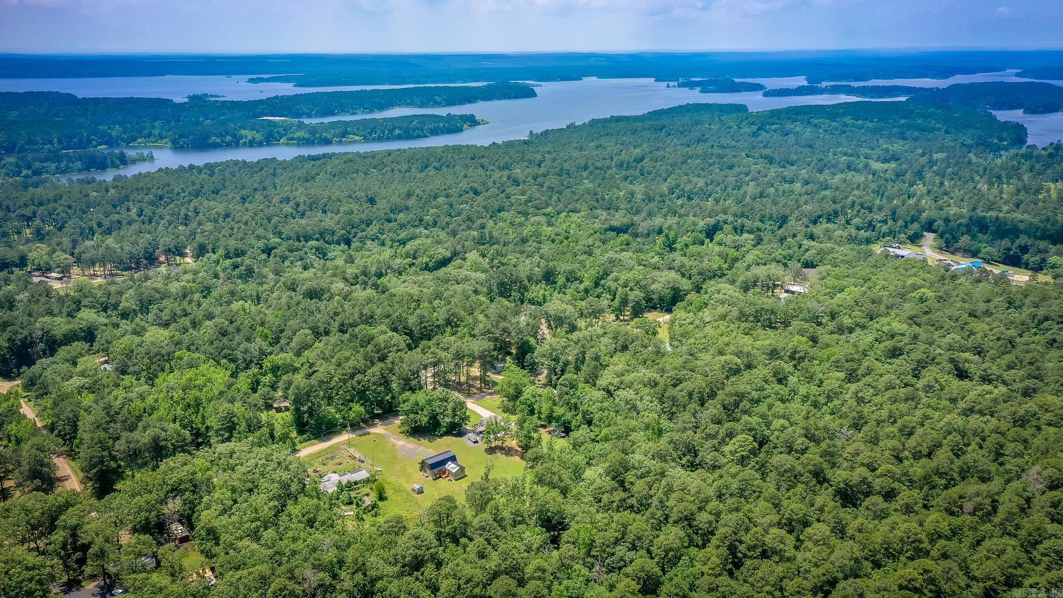 Discover your dream country retreat just one mile from DeGray Lake’s crystal waters. Nestled on a full acre, this 3-bedroom, 2.5-bath cabin (2,412 sq. ft.) offers a main-level primary suite plus two upstairs bedrooms perfect for family, guests, or vacation rentals. Recent 2024 updates—including a new roof, HVAC, and high-speed fiber-optic internet—mean you can move right in and stay connected. Embrace outdoor adventure with boating and fishing on 13,800 acres of DeGray Lake, miles of hiking trails, and championship golf at DeGray Lake Resort & Spa. Hunters will love easy access to surrounding timberland and wildlife-rich public hunting areas. Just minutes from Bismarck schools, Hot Springs’ historic spas, and Arkadelphia’s Henderson State University & Ouachita Baptist University, this cabin delivers the perfect blend of peaceful country living and family-friendly fun. Schedule your private tour today and start living the ultimate lake and land lifestyle!