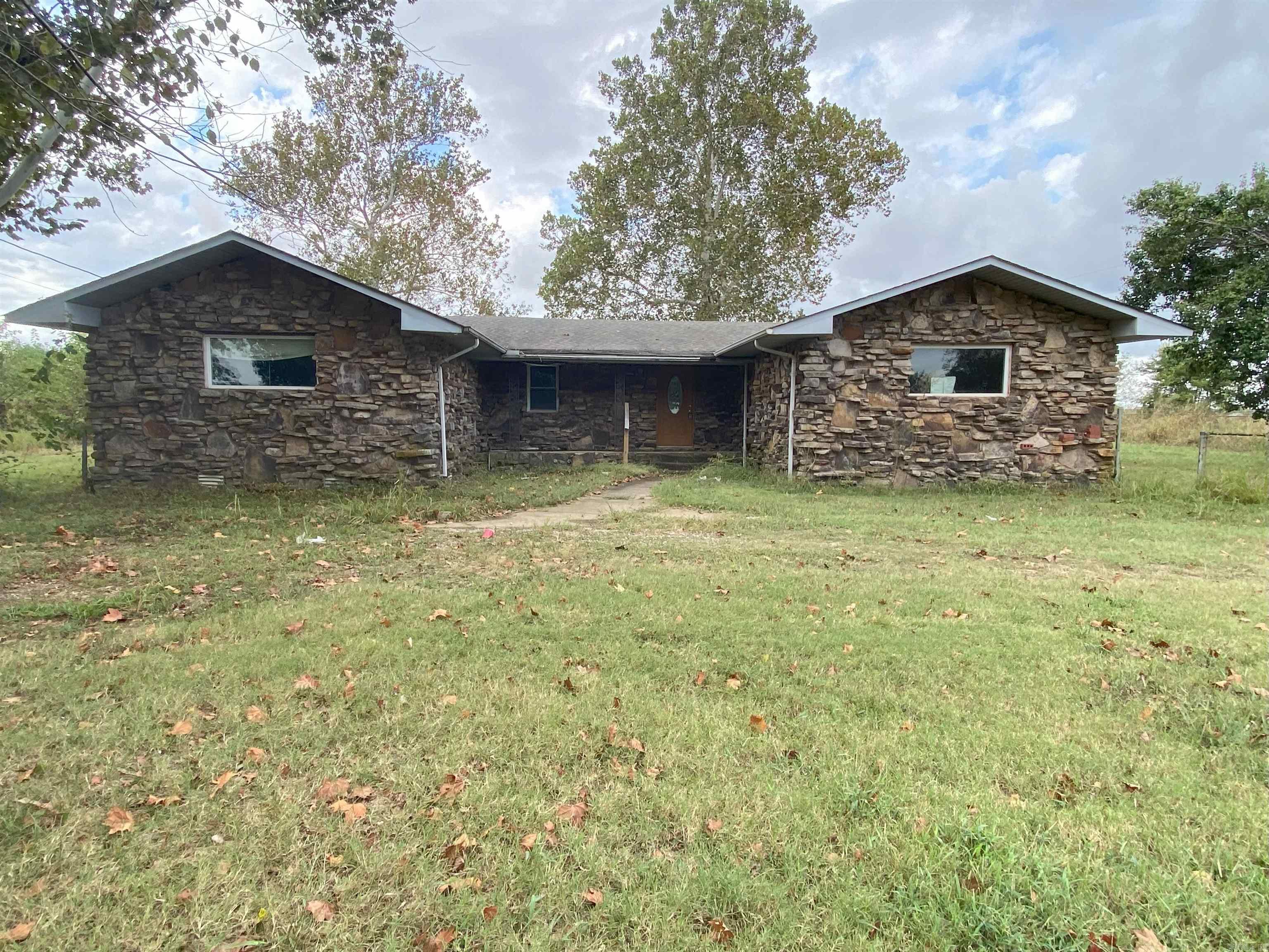 Investors take a look at this spacious 3-bedroom, 2-bathroom home that sits on a generous 1.12-acre country lot and offers endless potential. This home features a back deck to enjoy peaceful nights in the country. Spend the summer days relaxing by the pool in the backyard. There is a large, detached garage which offers many options including car storage, workshop or game room. Plumbing and electrical in the garage with the ability to finish it out as a studio apartment. The home will require some shoring. Bring your vision and your tools to make this home an ideal country retreat. This home is sold As-Is. Seller will make no repairs. Utilities will not be turned on.