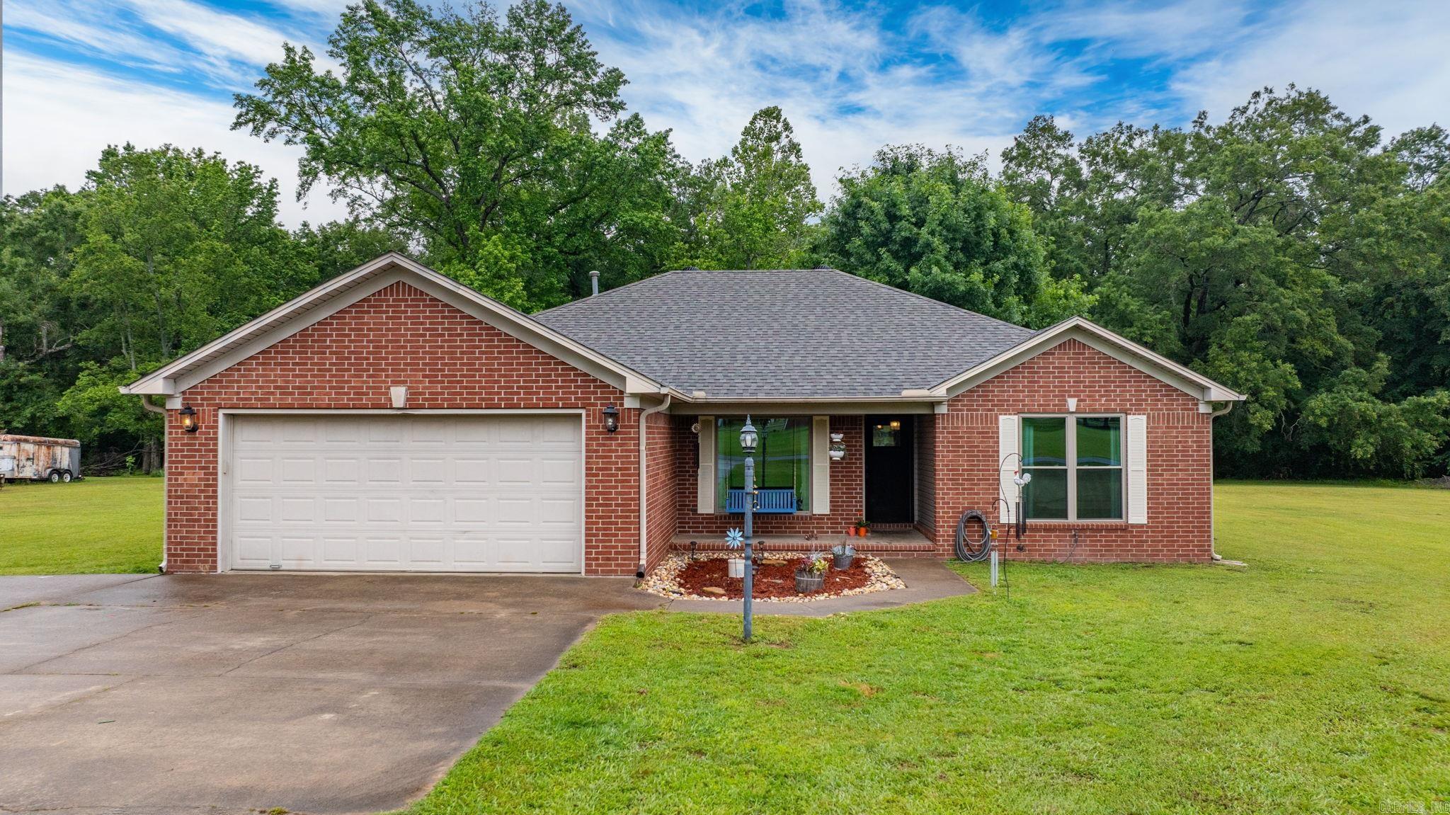 This super charming 3-bedroom, 2-bath brick home sits on a fantastic 1.78-acre lot just 5 miles east of Conway in a quiet area within the Vilonia School District. Details like a Dutch door and updated windows add to the country feel, while beautiful crown molding and tray ceilings in the living room, dining room, and master bedroom elevate the home's character. The well-maintained interior features a gas fireplace in the family room, Silestone countertops in the kitchen, and a dedicated laundry room with lots of storage. Outside, you'll find a 24x24 workshop, additional covered storage, and storybook views from the spacious yard. With an attached two-car garage, city water, and a septic system, this home offers the perfect blend of charm, comfort, and convenience.