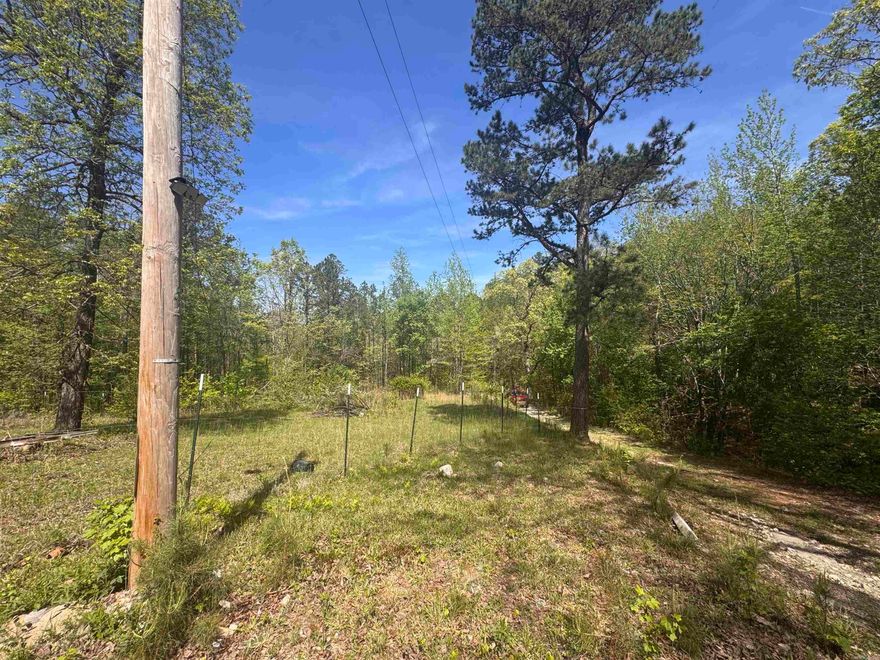 Ready to build or bring in a mobile home...this 5.6 acres in Fountain Lake School District has an electric pole, well, and septic already on site. Enjoy seclusion and tranquility with a large portion of the property fenced in for pets as you enjoy beautiful scenic views. From the wet weather creek to the mountain skyscape, you'll be at home with nature.