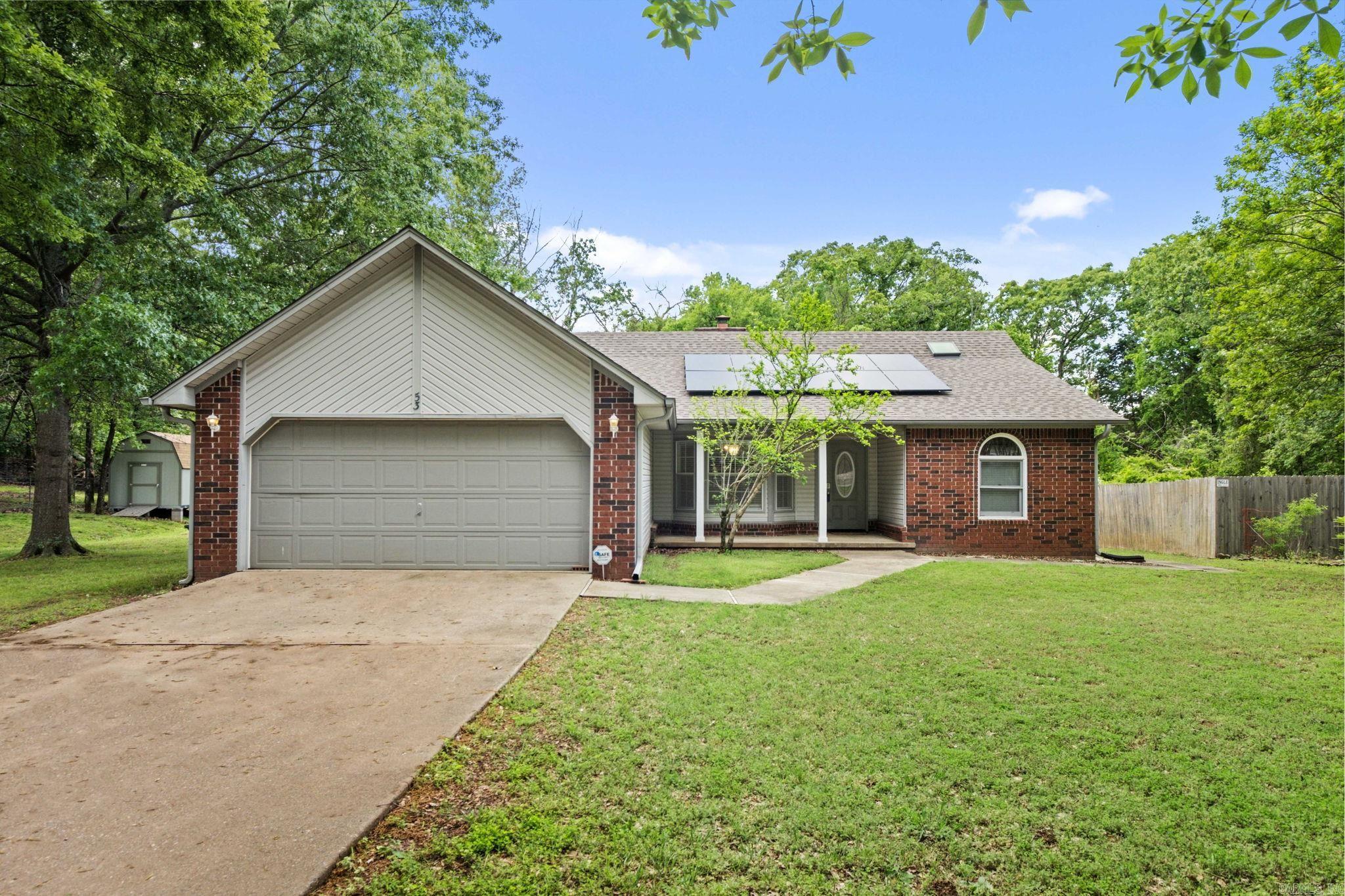 PERFECT HOUSE..PERFECT PRICE..AND PERFECT LOCATION!!! Oh so Cute & Move In Ready! This home Features 3 Bedrooms & 2 Full Baths! A nice Entryway Opens to a Large Great Room with Vault Ceilngs and Fireplace! The Kitchen is Partially Open to the Living Room and Features a Nice Breakfast Area, B'fast Bar, Stainless Appliances & Plenty of Cabinet Space! The Master is Split with HIS/HER Vanities and Walk-in Closets! Both Spare Rooms are Large and Share a Nice Hall Bath with a Skylight. The Backyard is an Oasis surrounded by Trees and Privacy with a Nice Deck for Sitting and Enjoying & Fully Fenced with Gates on Each Side! Cute Front Porch for Rocking and Conveniently located to Town! Other Features include Solar Panels for Efficiency, Central Vac, and Washer/Dryer/Fridge Stay! APPRAISERS-SEE REMARKS REGARDING SOLAR PANELS