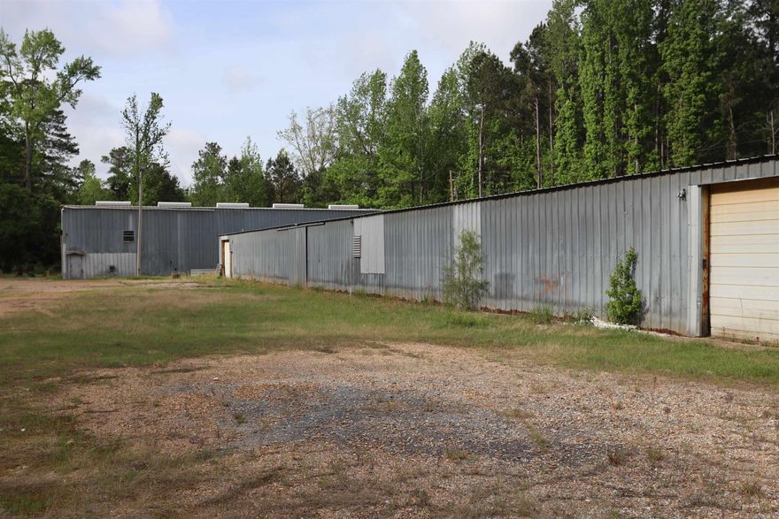 Commercial Opportunity on 2.2 acres - Endless Potential! Priced to sell!  Two large red iron buildings situated on 2.2 acres with city water and sewer connections, offering incredible flexibility for a variety of uses. The first building boasts approximately 5,000 square feet and is ideal for a mechanic shop or similar operation. With ample height, it can easily accommodate large trucks and heavy equipment. The second building offers approximately 1,500 square feet of open space! Includes a built in apartment featuring a kitchen, bedroom, and bathroom, perfect for on-site living, rental income, or office space. Whether you're looking to start a business, expand operation, need storage space, or invest in a versatile property, this one has the space and features to make it happen!