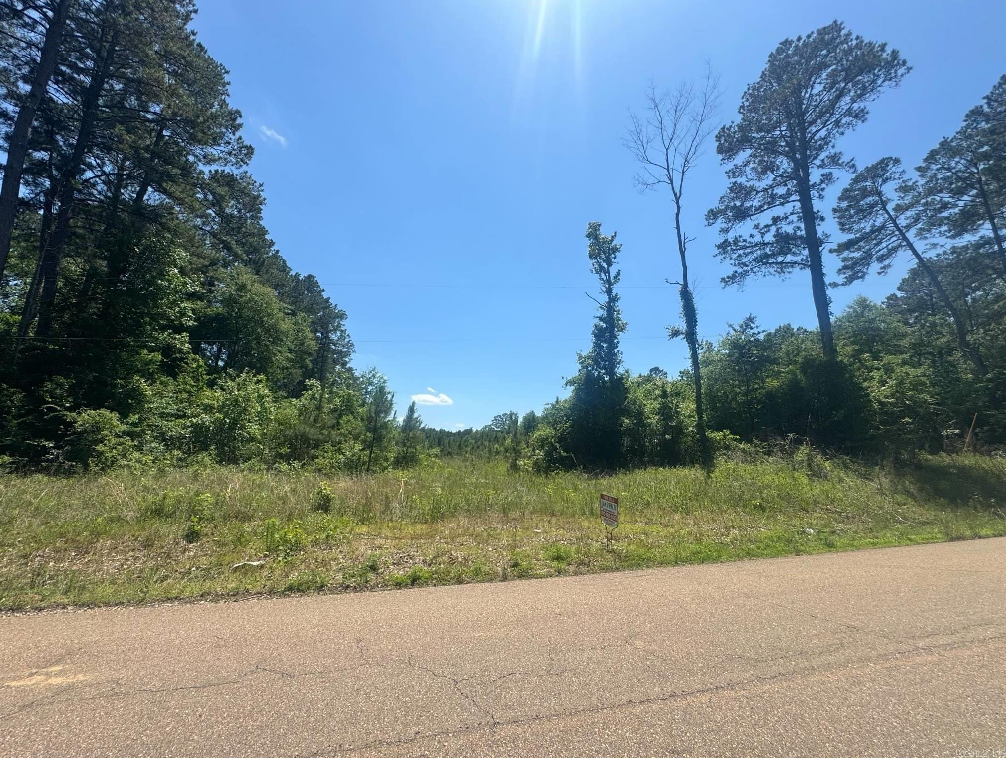 This property is situated just outside of El Dorado on quiet Philadelphia Road, offering a peaceful rural setting with convenient access to town. The land features a mix of wooded areas and open ground, ideal for those seeking privacy and natural surroundings. There are no structures or utilities currently on site, making it a clean slate for future development or recreational use. With paved road frontage and a quiet atmosphere, this location offers the best of country living not too far from local amenities.