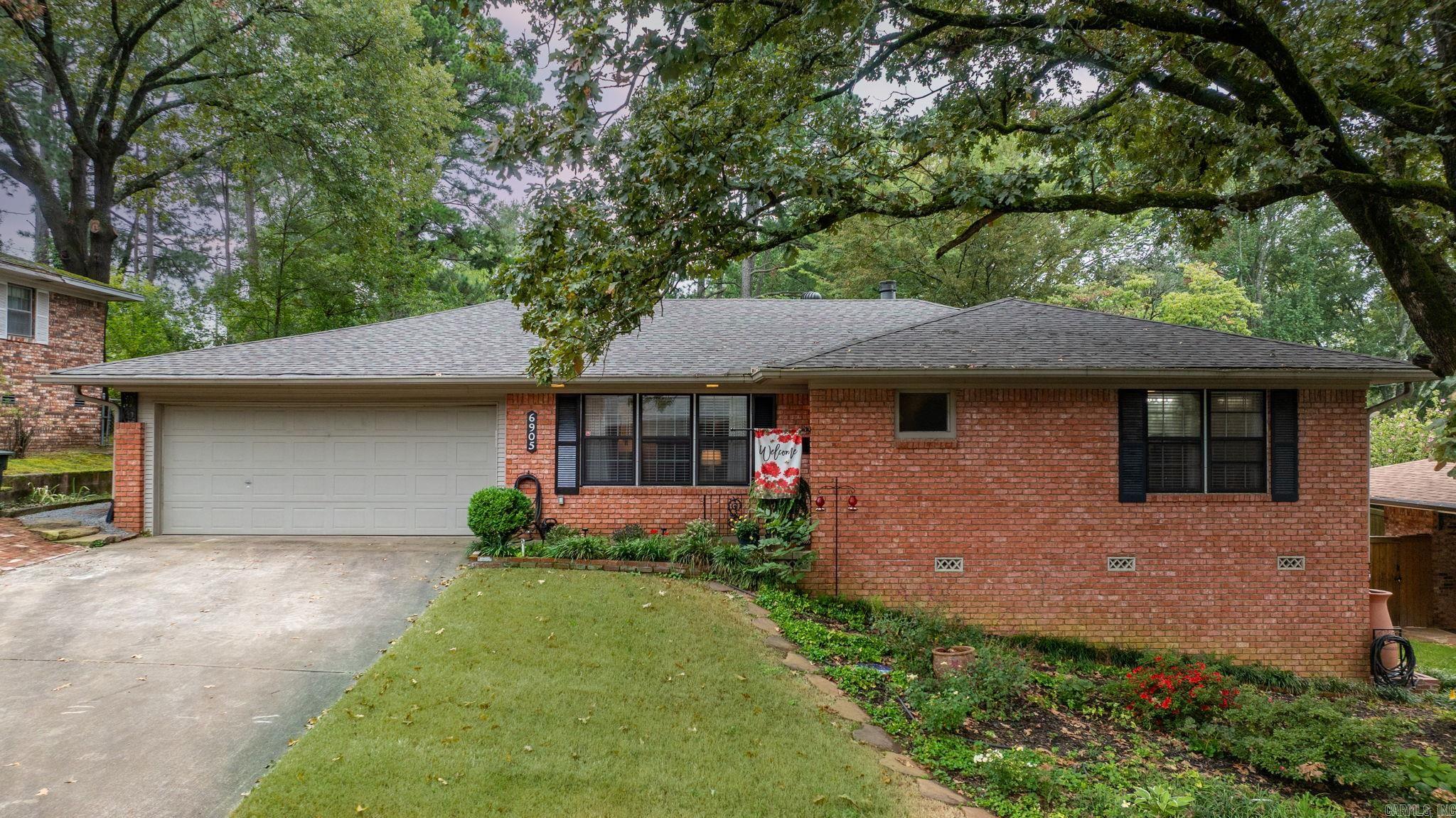 There is no place like HOME-- cozy and comfortable either as you are relaxing by the fireplace in the den or enjoying the weather on the large covered brick patio. Through the front entry, you are welcomed into a large open living and dining room with beautiful hardwood floors. Kitchen has an island, large pantry, new 5-burner gas range, new double ovens and an eat-in area. Separate laundry room with counters/cabinets. Flowing from kitchen is a den with gas log fireplace with large glass sliding doors to the beautiful fenced backyard. All of these areas have new hardwood floors. 2 roomy bedrooms with each having a full bathroom. One bedroom has a Murphy bed for versatile space. Fenced backyard has a fabulous covered porch, patio, new shed, new sod in front & back (2025), and gutters with rain barrels. Many improvements--new HEAT/AIR system with new ductwork 2024, new double ovens and gas range 2024, Sodded entire yard, added drains, gutters to back porch 2024. electrical upgraded for a house generator, Roof 2024, Patio Roof 2020. Another bonus--Refrigerator, washer and dryer, and front living room TV to convey.