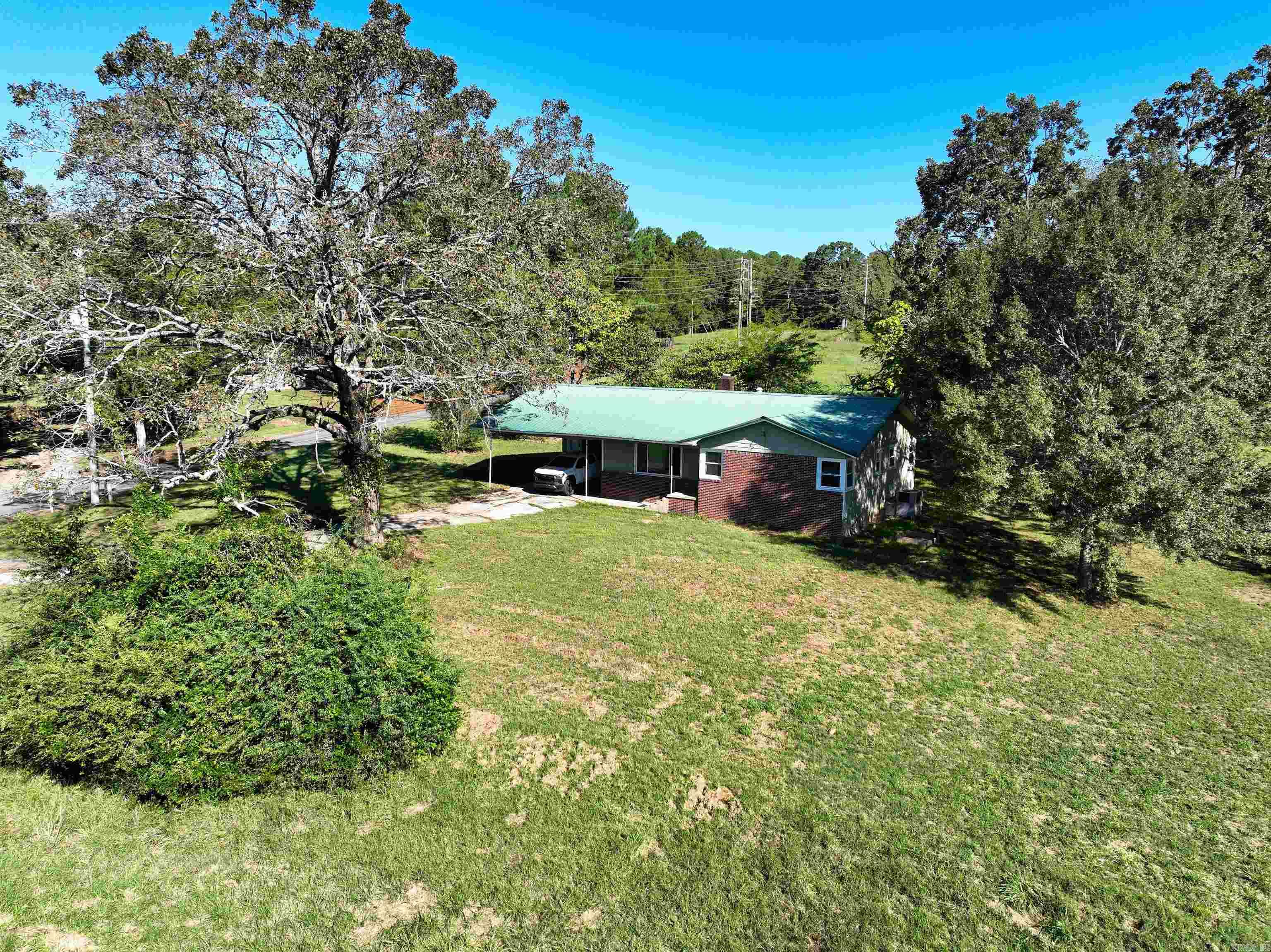 A rare residential and/or commercial development opportunity just outside the city limits of Heber Springs, offering panoramic views of the iconic Sugarloaf Mountain in a prime location near the Little Red River awaits. This property features 375 feet of Highway 110 E frontage, nearly 1000 ft of Sugarloaf Ln frontage, nearly 6 acres of developable land, and a 1,454 SF home with authentic polished wood flooring and fresh interior paint throughout! The land is cleared and ready for an investor or business to maximize its potential. The front acreage is ideal for commercial development, mixed use, restaurant, medical, or retail, while the back acreage could be reserved for residential use. Alternatively, the entire property presents a turnkey opportunity for an RV outdoor living park, or auto park with a design for additional commercial use on site as well. Sugarloaf Ln is Located directly across from the Sugarloaf Dance Hall, Mountain Trailhead system, and a short walk to the ASU Beebe Commuter Campus, this property is perfectly positioned for visibility and growth.