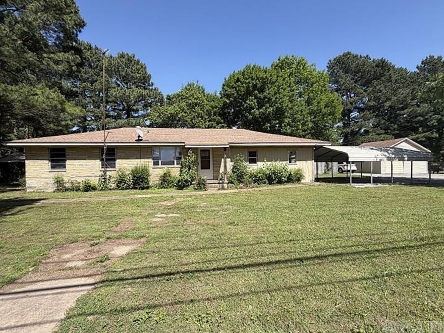 Located in the small community of Pleasant Plains, Arkansas, this property offers an opportunity for buyers looking to restore and reimagine a home in an area known for its quiet setting and proximity to outdoor recreation, including the nearby White River region. Pleasant Plains provides convenient access to Batesville while maintaining the slower pace and small-town atmosphere many buyers seek. From the front entry, the layout opens into the living room with a direct flow into the kitchen and dining area, leading out to the backyard deck. Off the living room, the laundry room includes a half bath, utility area, large closet, and access to the attached carport/garage space. A hallway on the opposite side of the home leads to the guest bathroom and bedrooms. Additional features include multiple detached carports, a storage building, covered patio, storm shelter in the front yard, propane tank, and crawl space. With updates and repairs, this property offers potential for those seeking space, utility, and the flexibility to create a home aligned with their vision.