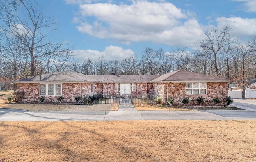 One-level traditional home in Quail Creek Estates, just minutes from the Maumelle backside off Hwy 365 (MacArthur corridor), situated on 1.76 level acres. This 4-bedroom home offers 2 full baths and 2 half baths, plus an additional half bath at the pool gazebo and another half bath in the heated shop. Features include a 4-car garage, wood and tile flooring throughout (no carpet), granite countertops, copper sink, central vac, fiber optic internet, and 4 surveillance cameras. The backyard is fenced with extensive composite fencing and brick columns, fully enclosed and accented with LED lighting. Outdoor amenities include an 18x36 in-ground pool, hot tub (motherboard replaced 2022, new cover), covered patio, and pool gazebo. Heated shop includes electricity and half bath. Updates include new ceiling fans (2023), chair-height commodes (2023), remodeled hall half bath (2023), primary bedroom flooring (2022), primary bath linen cabinet (2023), septic pumped (2022), LED fence lighting (2023), and pool jets sealed (2023). Pool ecosystem system with copper plates available. (Pool light inoperable) Exterior Iron front gate installed 2025. New Roof being installed week of 2/23/2026.