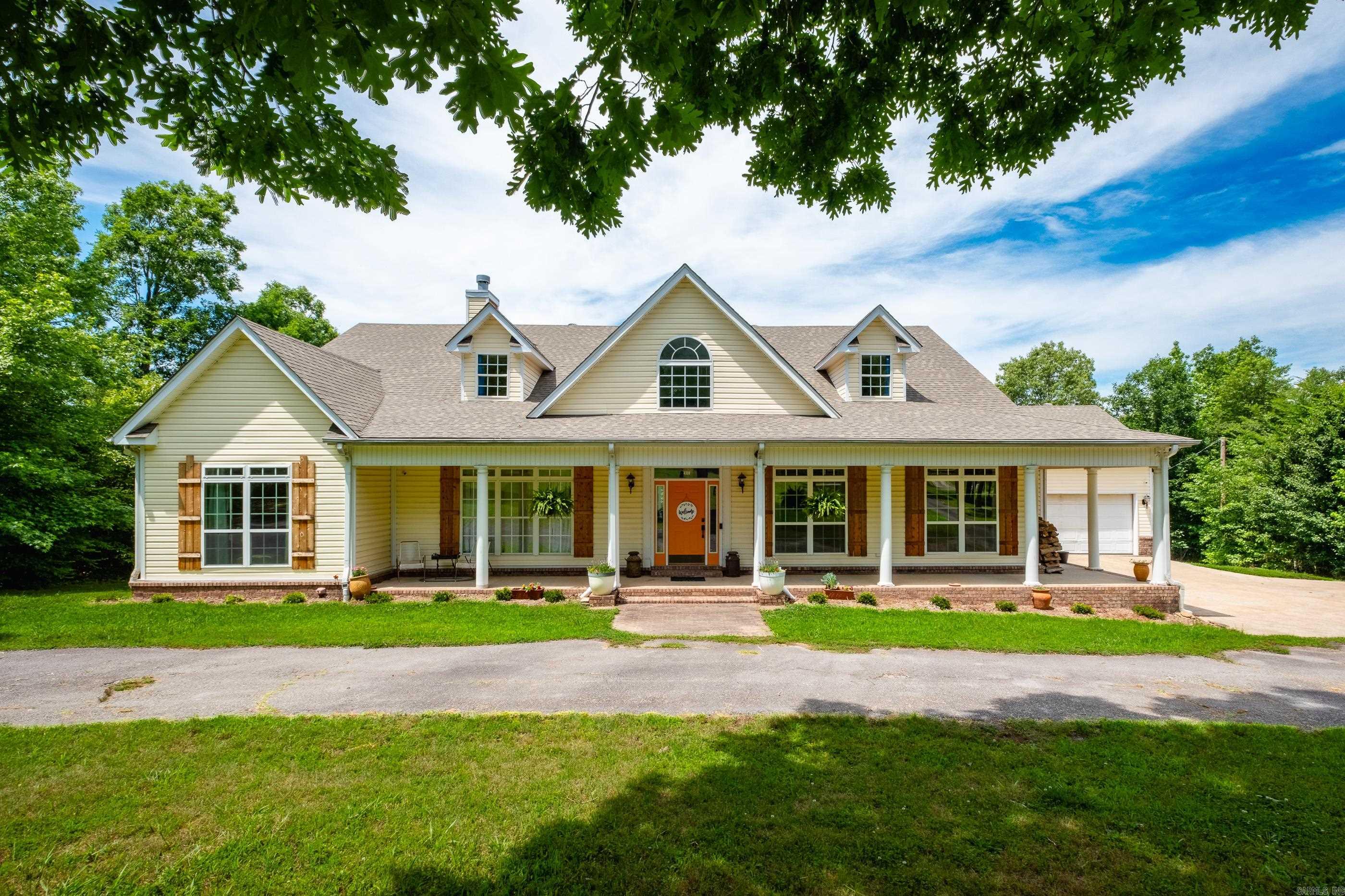 Enjoy the perfect blend of privacy and convenience in this spacious, fully renovated home nestled on 9 stunning wooded acres. From the moment you step inside, the vibrant pine floors and open-concept layout make a lasting impression. The main level boasts a home office and four generously sized bedrooms, each with walk-in closets, including a private primary suite thoughtfully separated from the others for added tranquility. Don't miss the floor-door access to a storm shelter in a closet of a guest bedroom! Upstairs, you'll find a massive bonus room and an additional full bathāideal for a playroom or guest suite. Step out onto your private screened-in porch to enjoy the peaceful sights and sounds of nature. The property is a nature lover's paradise, home to a diverse array of mature trees, native plants, wildflowers, and abundant wildlife. Deer sightings are a regular delight right in your backyard. A rare opportunity to enjoy acreage, privacy, and modern comfortājust minutes from town amenities.