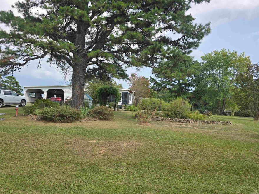 This absolutely stunning 10-acre property is a must see. This 1100 sq ft mobile home  has been added on to, to increase the square footage to 1866 sg ft! Additions include a 3rd bedroom, huge dining area, laundry room and entry way. Other additions not included in the square footage are an office area, sunroom and enclosed porch. It also has a screened in front porch and 2 car carport. This home sits on the most beautiful piece of property! 5 acres are gorgeously landscaped to include several types of blooming trees and flowers, blueberry bushes, grape vines, pear, cherry and fig trees, muscadine vines and asparagus that comes back every year! The 5 wooded acres provides a perfect place for the hunting enthusiast or nature lover. It has a creek that runs through it attracting all kinds of wildlife. The roof of the home was resealed in April of this year, and the water heater and heat & air system are approx. 3 years old. This home has so much more to offer, make your appointment today to see this stunning property! Sellers will have permanent foundation done to engineer's requirements if needed.