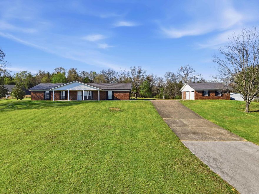 7.5 acres with this 3 bed 2 bath home/office has shop with 2 doors 25x32 and 2 car garage. 18x20 outbuilding, storm shelter, hobby storage building. animal fenced area.  Double oven,pantry and heater for other heat.