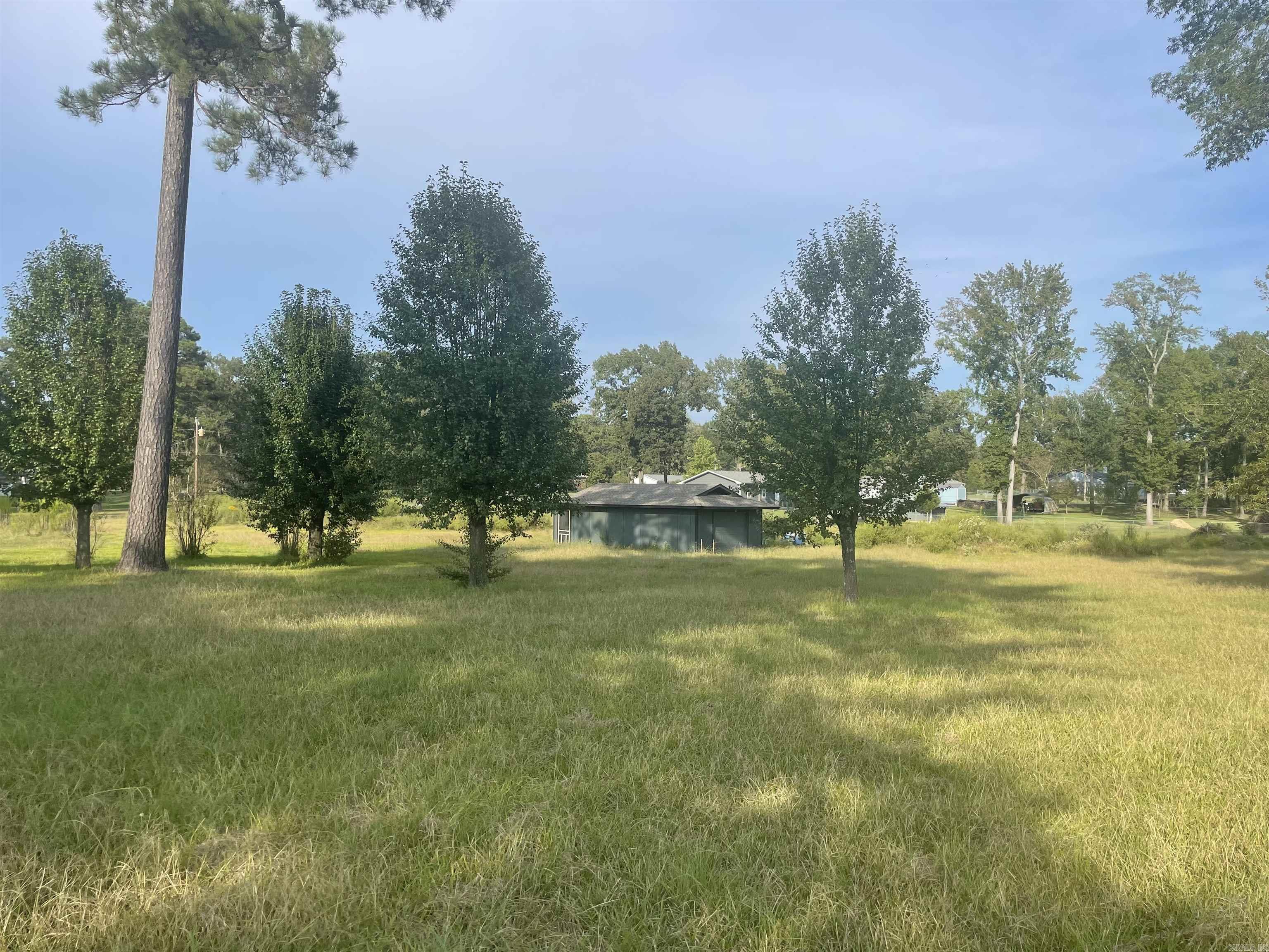 Beautiful piece of land that gently slopes off the highway. Previous home gone but slab and services still exist. Great place to rebuild or start new. No restrictions. Just outside city limits. Shop in back conveys. Has it's own well and services. 2 separate parcels, survey on file.