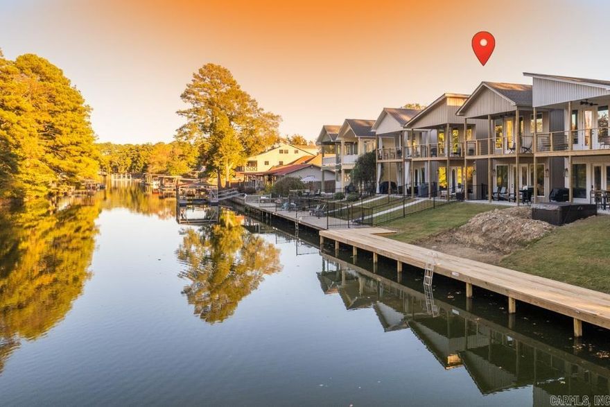 Enjoy the best of lake living at 221 Long Beach Dr on beautiful Lake Hamilton, perfect as a personal retreat with proven short-term rental potential. Ideally located just off Central Avenue in Hot Springs, you're just minutes from shopping, dining, and local attractions while still enjoying a peaceful waterfront setting. The open concept layout connects the living, dining, and kitchen areas, creating an inviting space for everyday living or hosting guests. An upstairs balcony offers a relaxing spot to take in lake views, while the game room, currently set up in the two car garage, adds both fun and strong appeal for short-term rental guests. The primary suite is a standout, featuring a private ensuite with two walk-in closets and a massive walk-in shower, providing comfort and functionality for full-time living or extended stays. An additional office offers flexibility and can easily function as a fourth bedroom. Step outside to enjoy direct lake frontage, complete with a 30-foot boardwalk with cleats for tying up boats, ideal for easy water access sunset views. This home works equally well as a full-time residence, weekend getaway, or income-producing STR. Schedule your showing!
