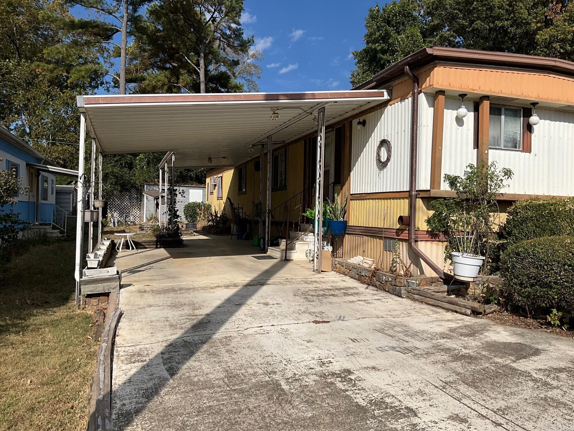 MOBILEHOME ONLY NO LAND!!!!!!!! AFFORDABLE living in this nice MH that has 2 bedrooms AND 2 baths (second bedroom also has bath access). Amenities include a newer 3 ton heat pump unit, a 10x20 storage bldg, a 7x7 attached storage/craft/workshop WITH an ac unit. Also, it is mostly furnished AND it is partially fenced. There is a large carport and TWO covered patios! AND the lot rent is very reasonable at $200.00!!