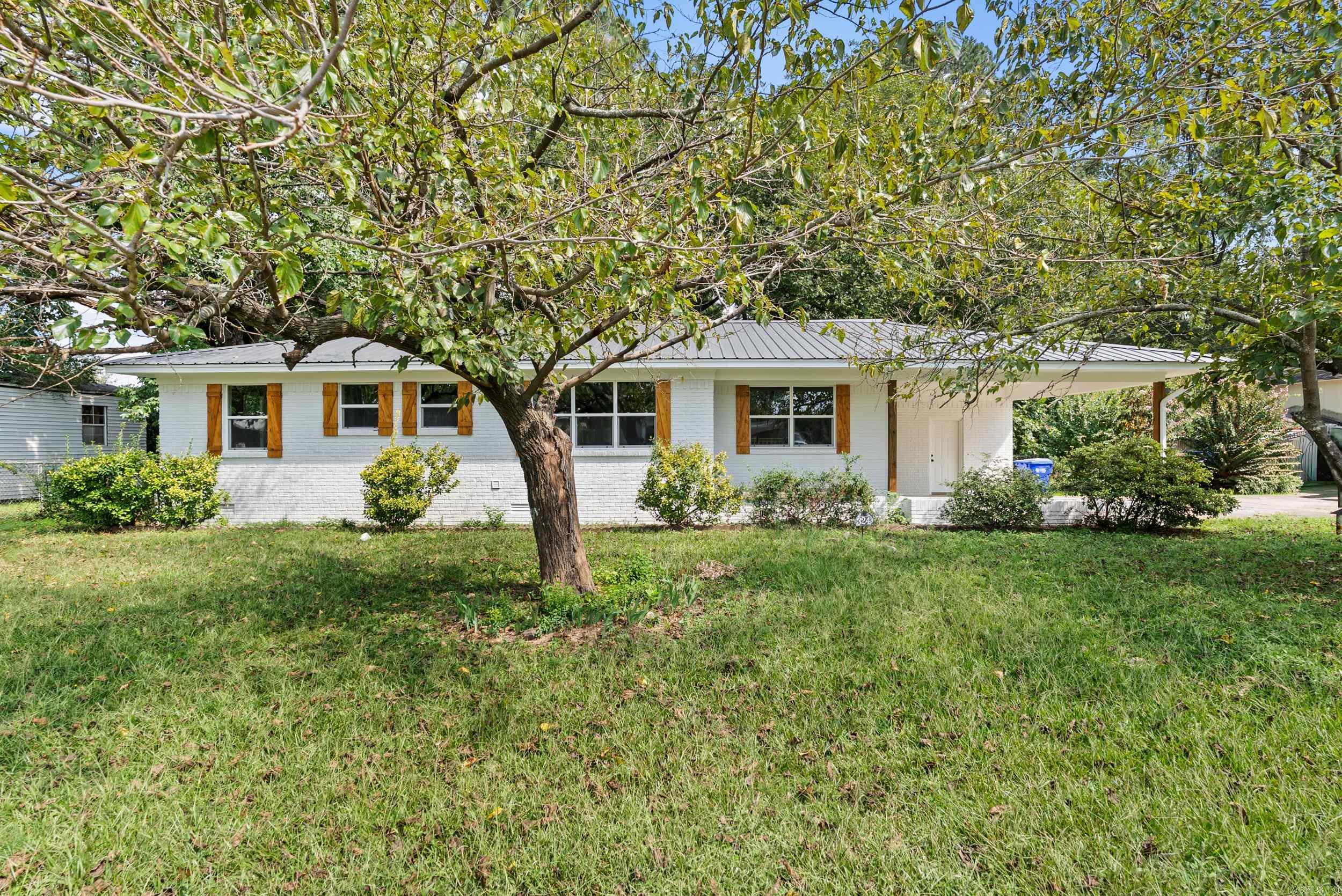 Don't let high interest rates keep you from buying! Seller is offering up to 6% seller concessions with offer acceptable to seller! This can include closing costs, prepaids, and/or interest rate buy-down! Stunning remodel in Old Town! This meticulously remodeled home oozes character. What a beautiful setting amongst the shady tree canopy. New wood shutters and posts with the painted white brick give the home great curb appeal. Inside, you'll find a spacious floor plan with dining area that is open to the living room and kitchen. Tons of natural light in the living area thanks to the sliding glass door that overlooks the back deck. The kitchen features all new appliances, painted cabinets, and granite countertops. 3 bed/2 bath with custom tile shower in the hall bathroom you have to see in person! Ensuite bathroom off the primary bedroom which is hard to find for this price in Old Town Conway! All new deck, which is perfect for grilling and relaxing in the evenings. Fully fenced (chain link) back yard. In-ground storm shelter. 2 car carport. Metal roof, which helps with insurance coverage. Great location! Close to Conway Station Baseball Complex and UCA. Photos virtually staged.